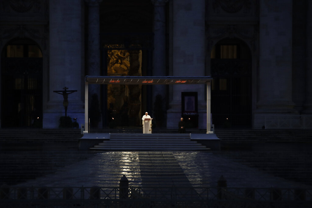 FILE - In this March 27, 2020 file photo, Pope Francis delivers the Urbi and Orbi prayer (Latin for To the City and To the World) in an empty St. Peter's Square, at the Vatican. Francis’ economy minister, the Rev. Juan Antonio Guerrero Alves, said the coronavirus pandemic, which reduced donations as well as revenue from the shuttered Vatican Museums, would contribute to a projected 30% reduction in revenue to 213 million euros in 2021, from 307 million euros in 2019, the last year available. (AP Photo/Alessandra Tarantino)