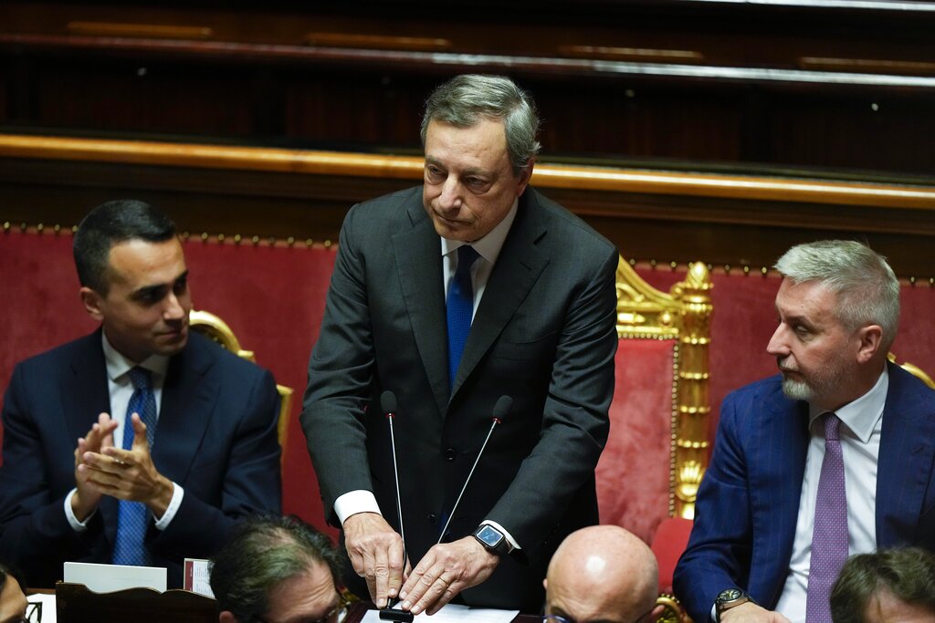 Italian Premier Mario Draghi pulls down the microphones at the end of his speech at the Senate in Rome, Wednesday, July 20, 2022. Draghi was deciding Wednesday whether to confirm his resignation or reconsider appeals to rebuild his parliamentary majority after the populist 5-Star Movement triggered a crisis in the government by withholding its support. (AP Photo/Andrew Medichini)