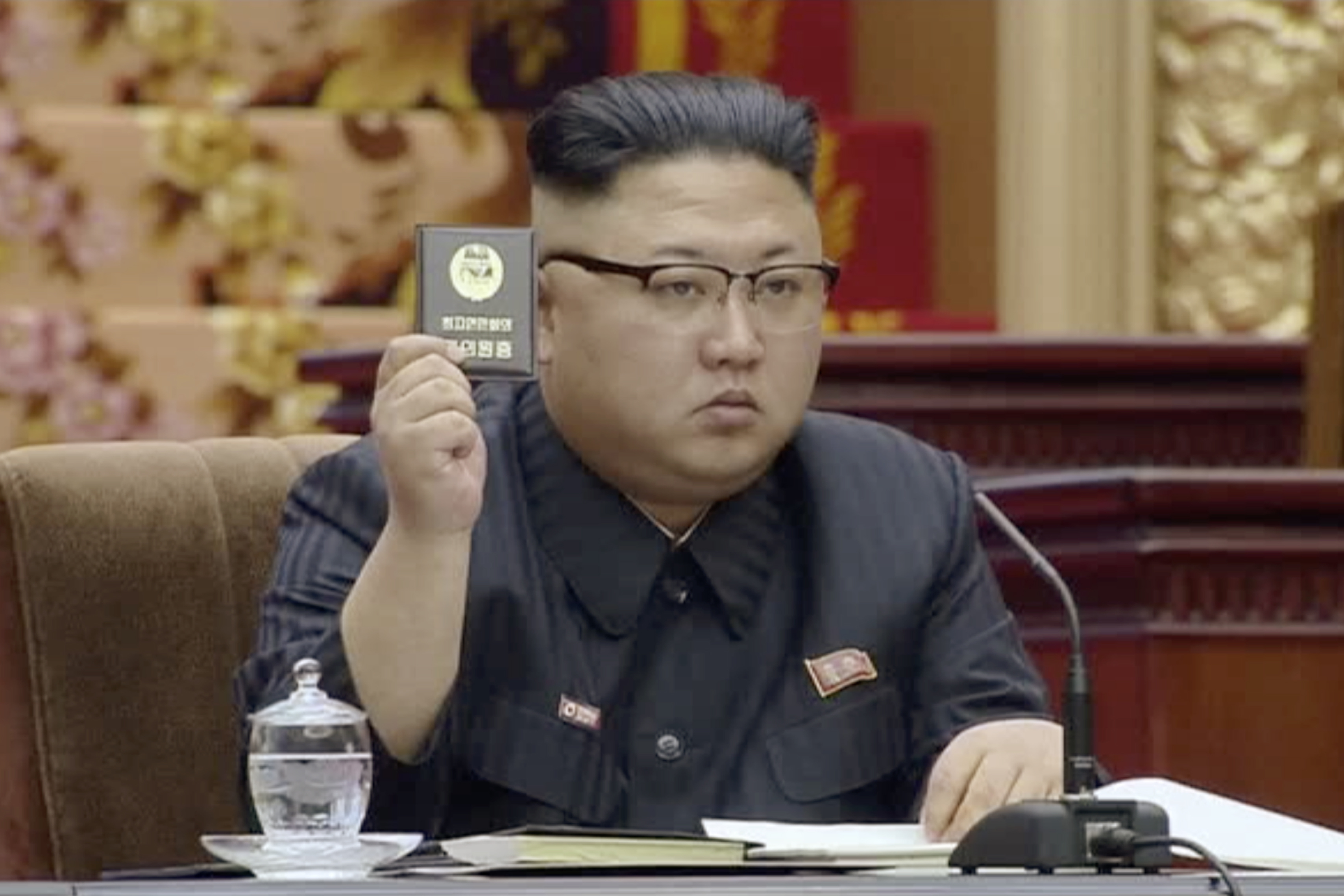 In this image made from video released by North Korean broadcaster KRT on Tuesday, April 11, 2017, North Korean leader Kim Jong Un holds up the Supreme People's Assembly card in Pyongyang, North Korea. North Korea's parliament convened Kim Jong Un taking the center seat. The Supreme People's Assembly normally meets once or twice a year at the Mansudae Assembly Hall in central Pyongyang. (KRT via AP)