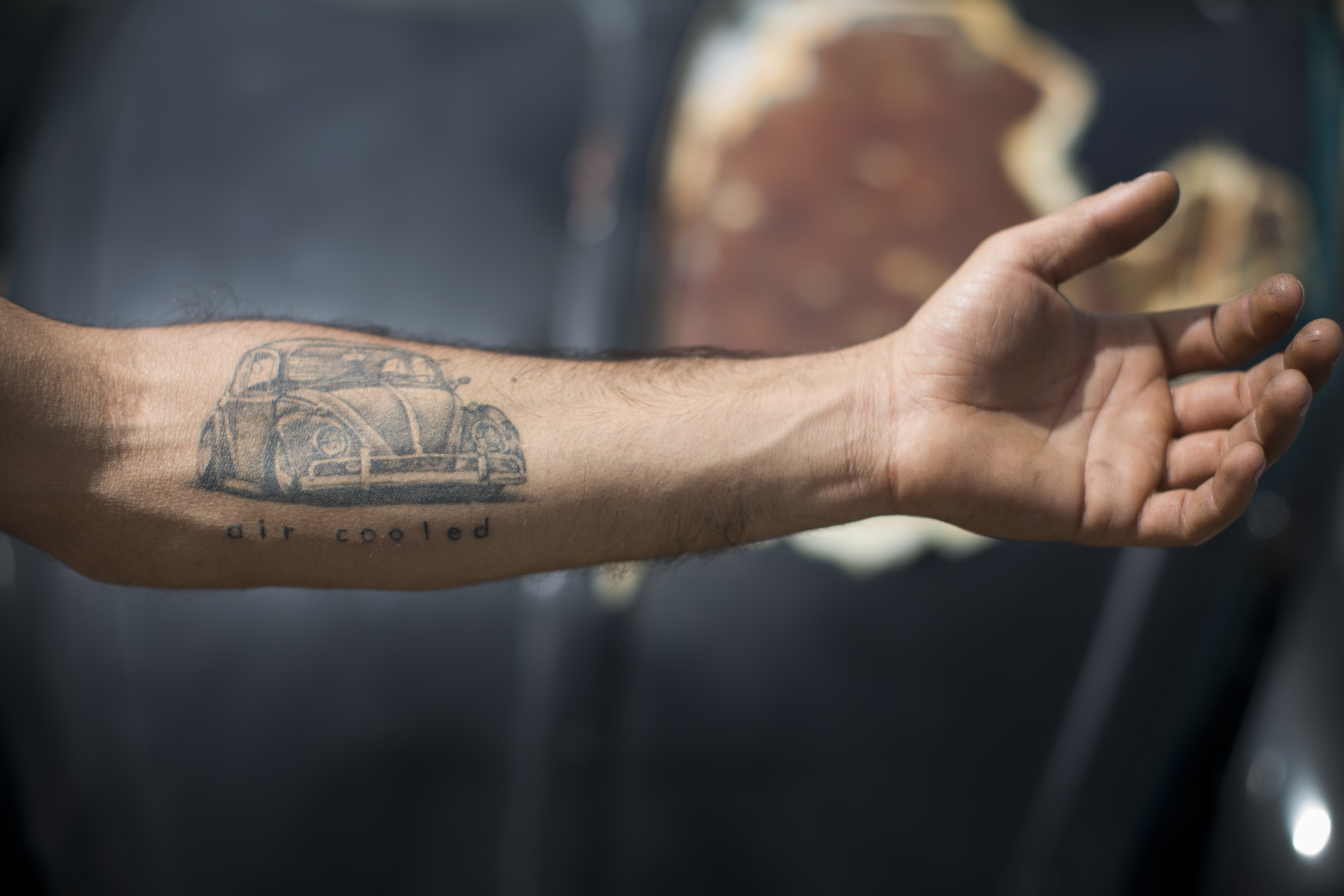 A Volkswagen Beetle owner shows his tattoo during the annual gathering of the 
