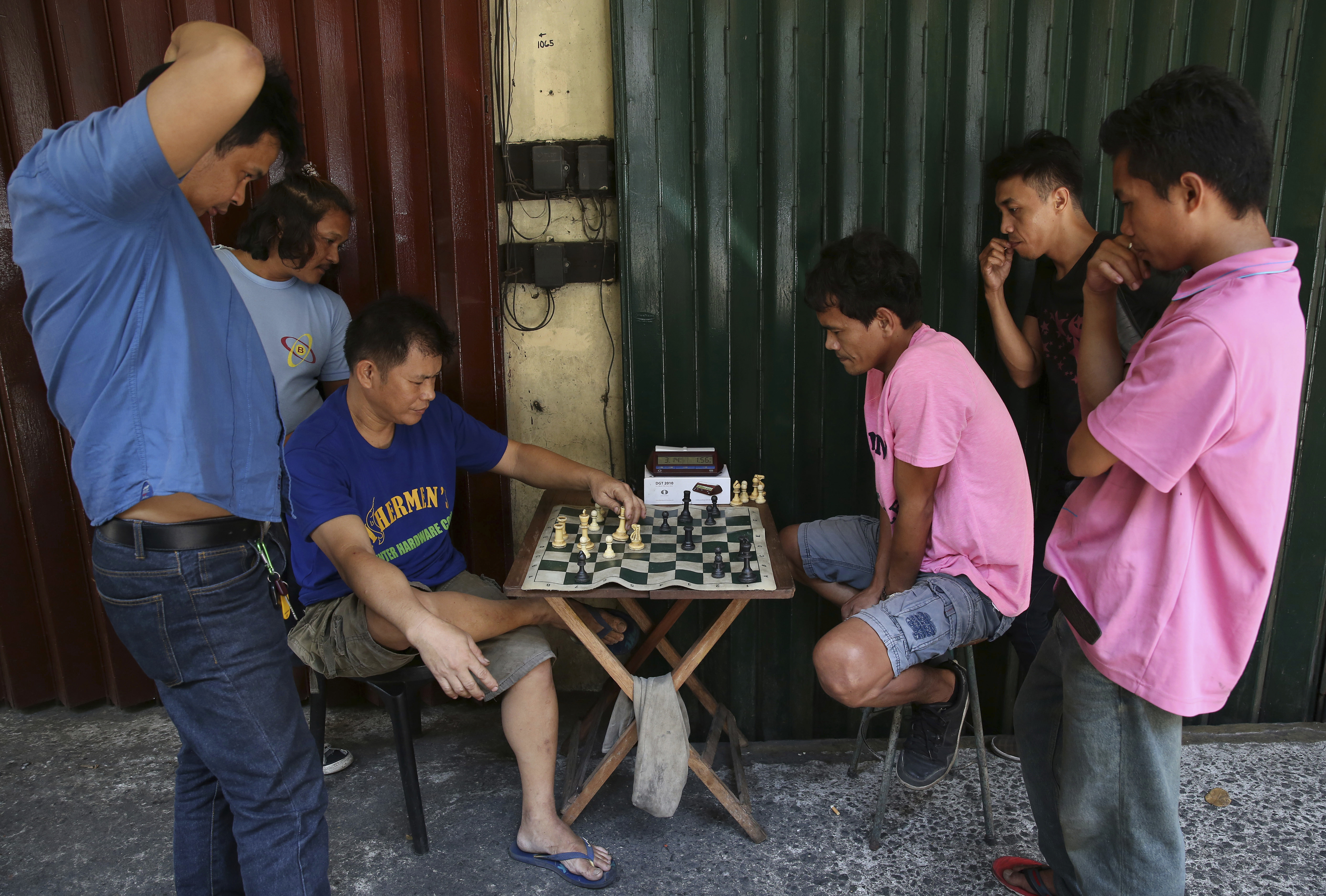 Workers play chess during their lunch break in downtown Manila, Philippines Tuesday, May 16, 2017. Chess is a popular game in the Philippines. (AP Photo/Aaron Favila)