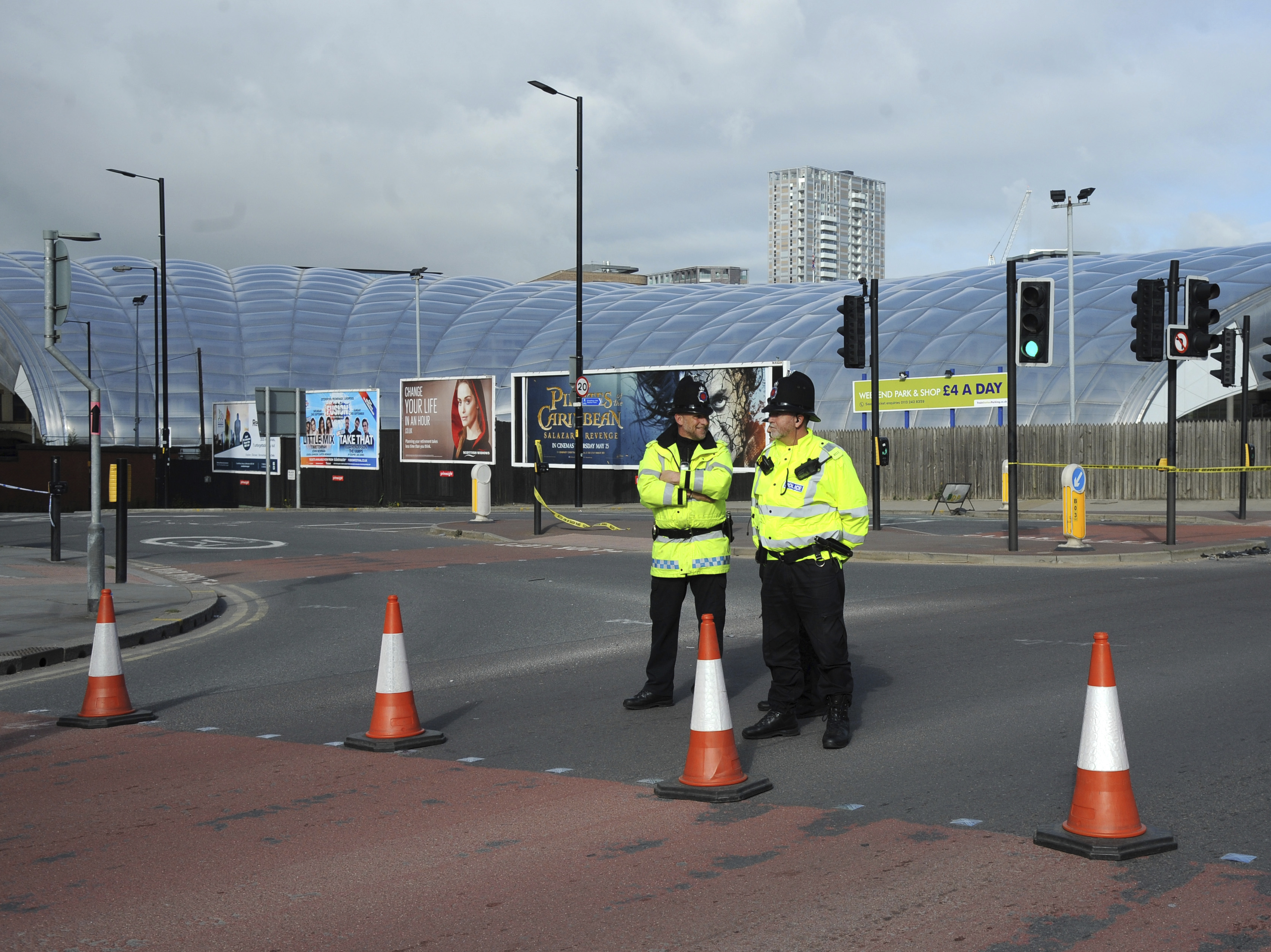 Police block a road outside the Manchester Arena in central Manchester, England Tuesday May 23, 2017. An apparent suicide bomber set off an improvised explosive device that killed over a dozen people at the end of an Ariana Grande concert on Monday, Manchester police said Tuesday. (AP Photo/Rui Vieira)