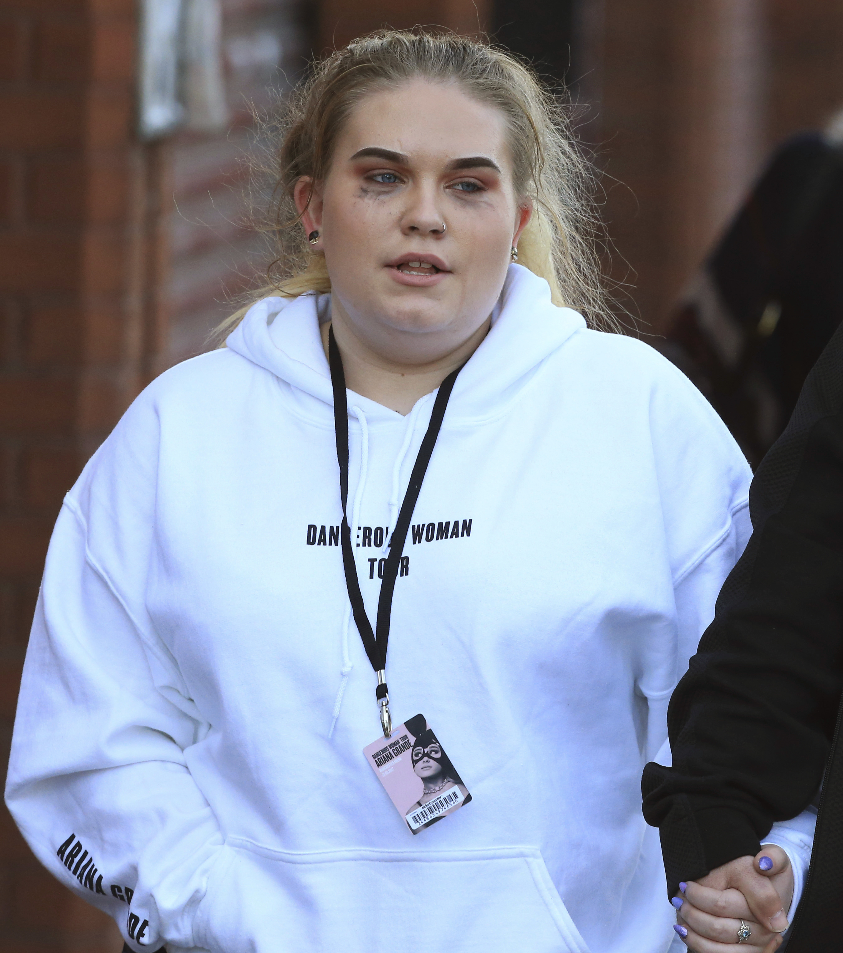 A fan leaves the Park Inn hotel in central Manchester, Britain, Tuesday, May 23 2017.  An apparent suicide bomber set off an improvised explosive device that killed over a dozen people at the end of an Ariana Grande concert on Monday, Manchester police said Tuesday.  (AP Photo/Rui Vieira)