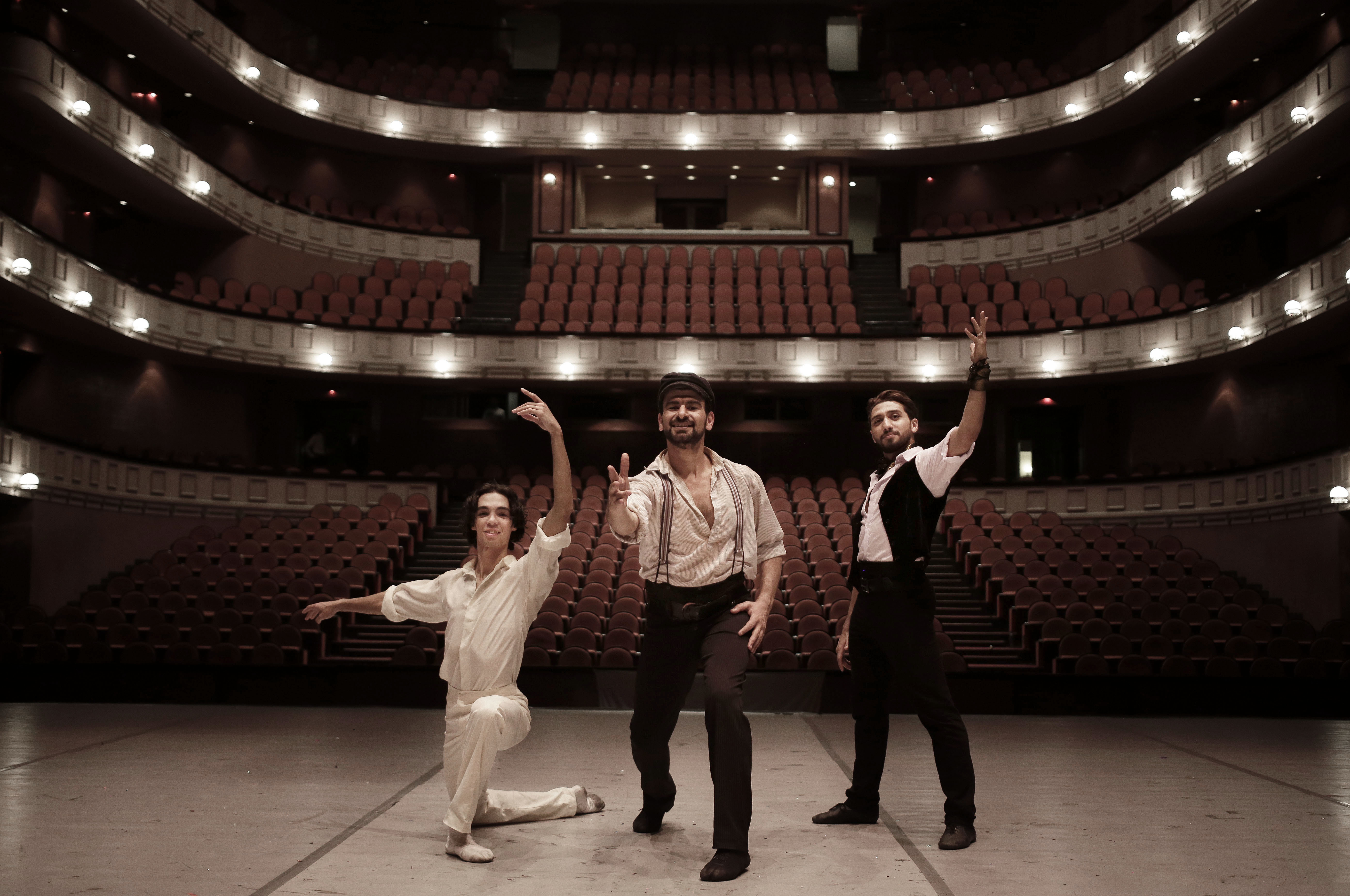 In this March 30, 2017 photo, Egyptian longtime friends and ballet co-stars Ahmed Nabil, left, Hani Hassan, center, and Mohammed Hamed, pose on stage after a performance of 
