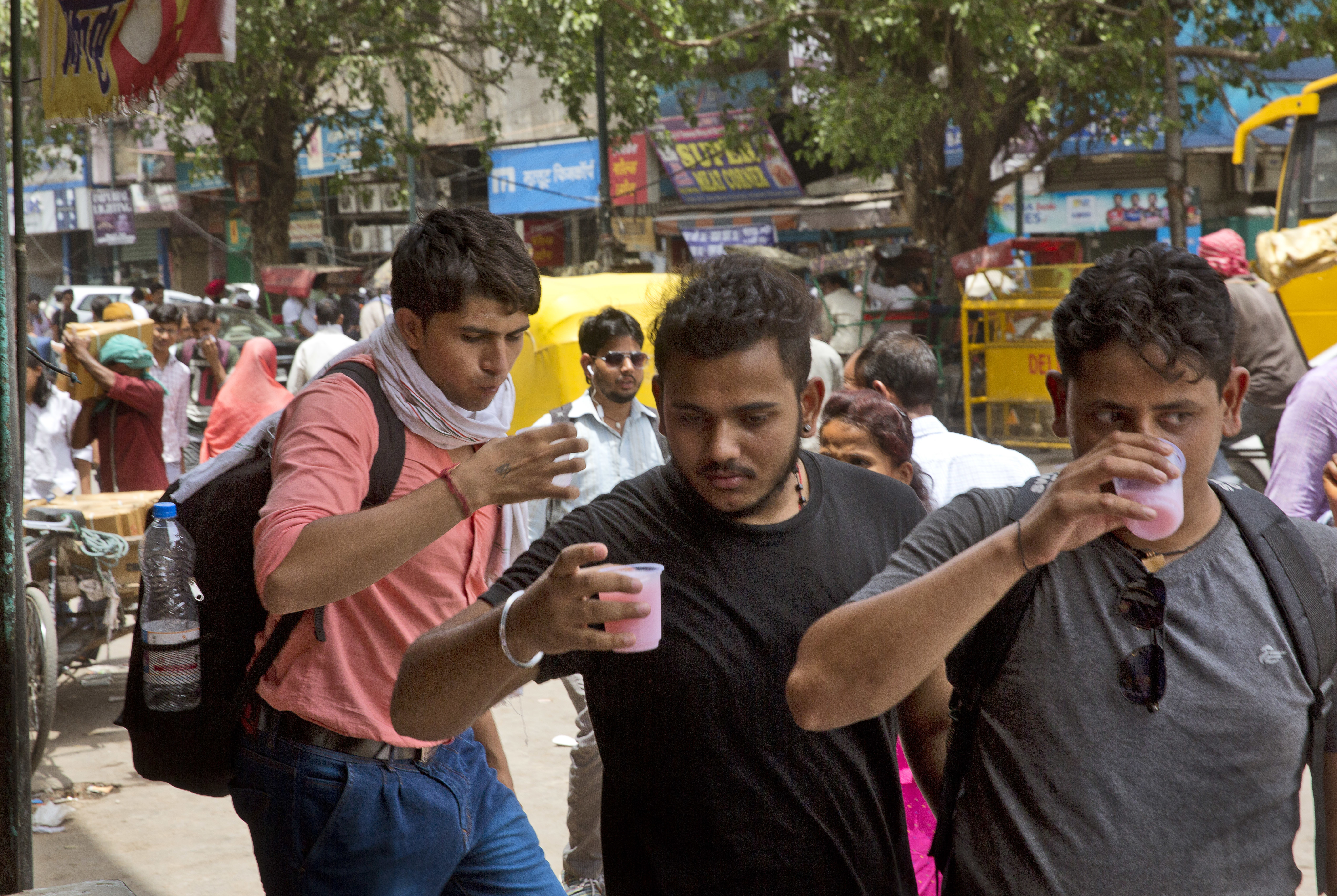 Indian commuters drink sweetened water being freely distributed by the wayside on a hot summer afternoon in New Delhi, India, Monday, June 5, 2017. Most parts of northern India is reeling under intense heat wave conditions with the temperature crossing over 43 degrees Celsius (109.4 Fahrenheit). (AP Photo/Manish Swarup)