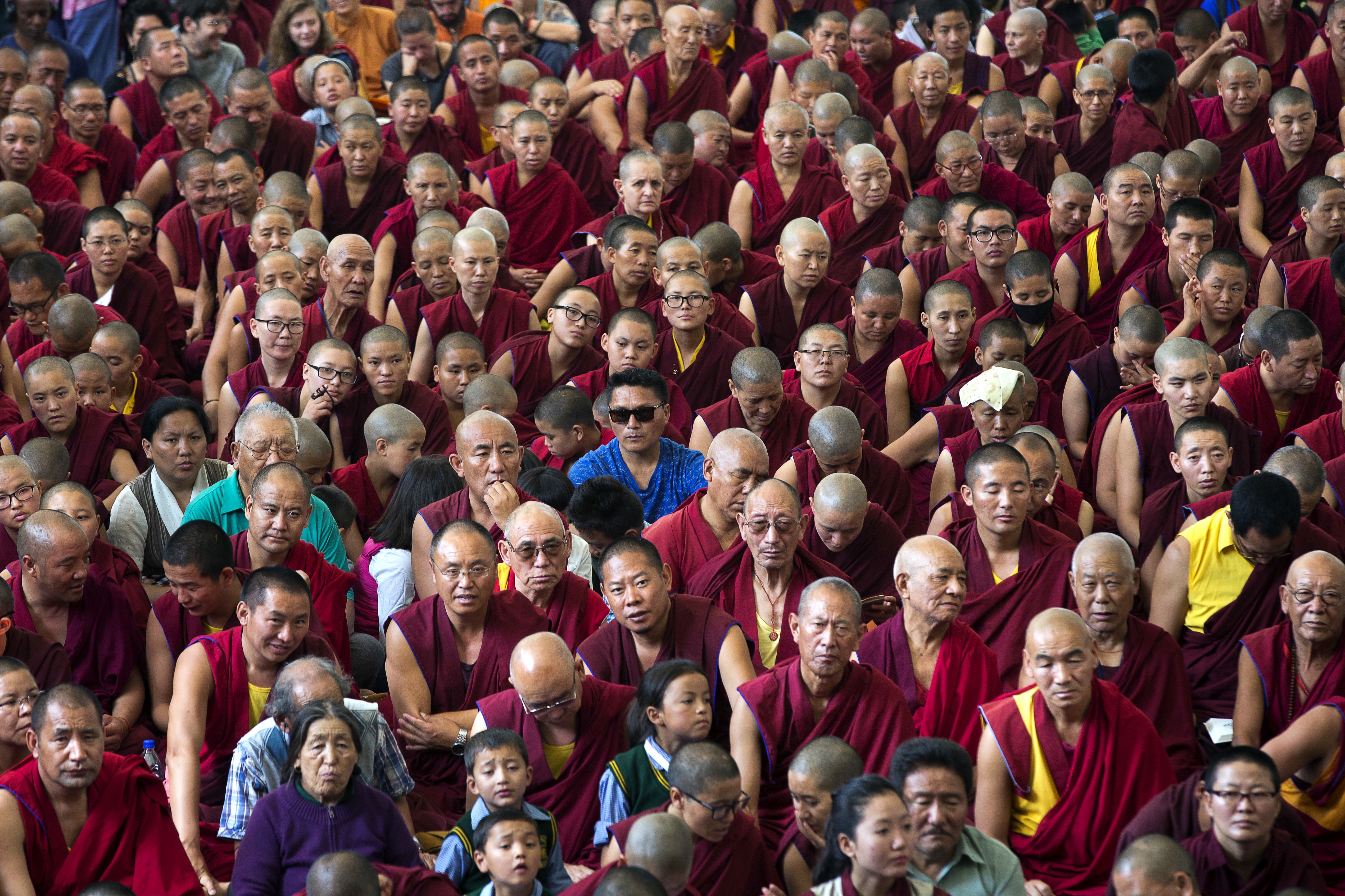 Tibetans listen to their spiritual leader the Dalai Lama as he gives a religious talk at the Tsuglagkhang temple in Dharmsala, India, Monday, June 5, 2017. Each year the Tibetan leader talks to young Tibetans on Buddhist philosophy and religion. The three-day talk will end Wednesday. (AP Photo/Ashwini Bhatia)