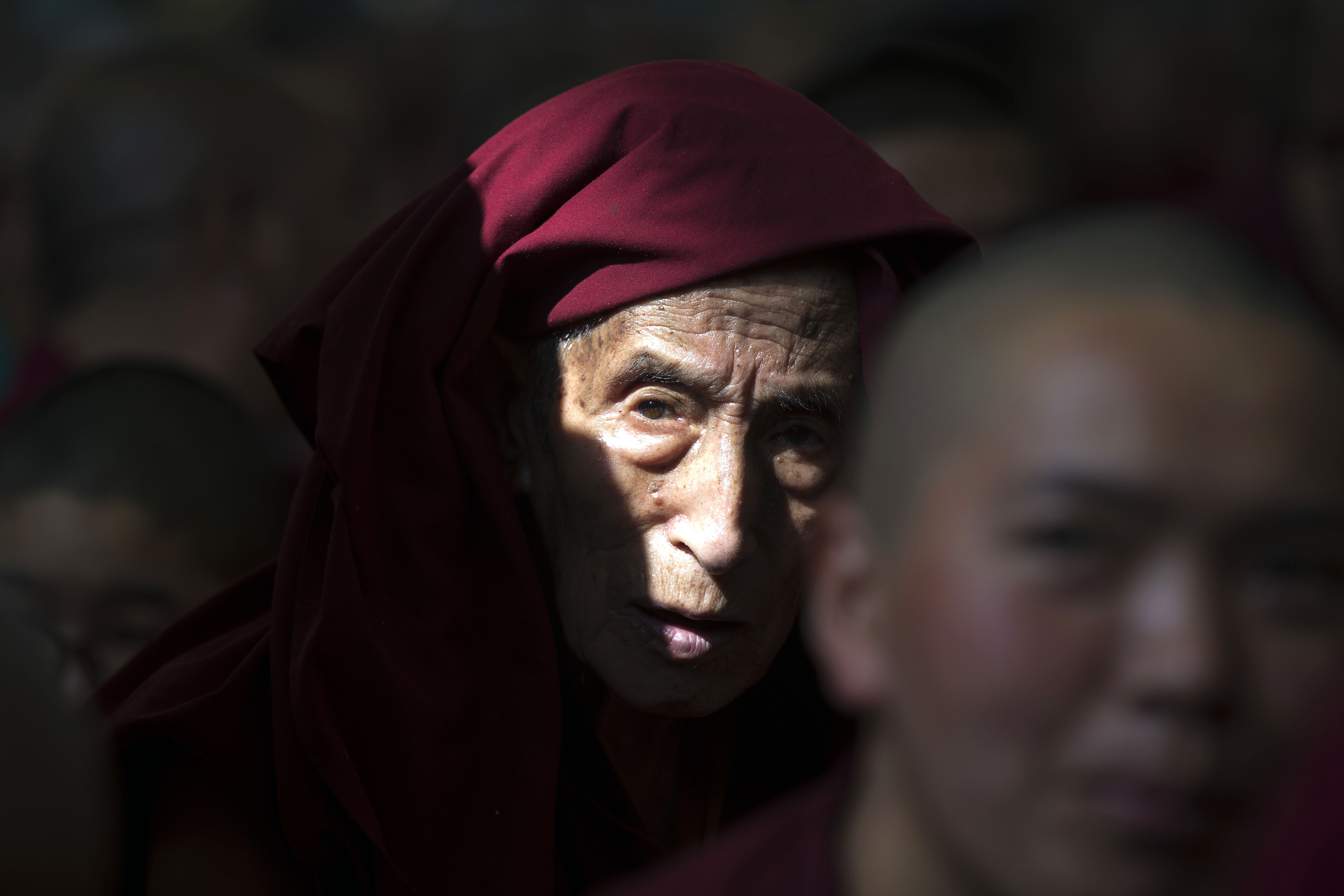 An exile Tibetan Buddhist monk listens to his spiritual leader the Dalai Lama's religious talk at the Tsuglagkhang temple in Dharmsala, India, Monday, June 5, 2017. Each year the Tibetan leader talks to young Tibetans on Buddhist philosophy and religion. The three-day talk will end Wednesday. (AP Photo/Ashwini Bhatia)