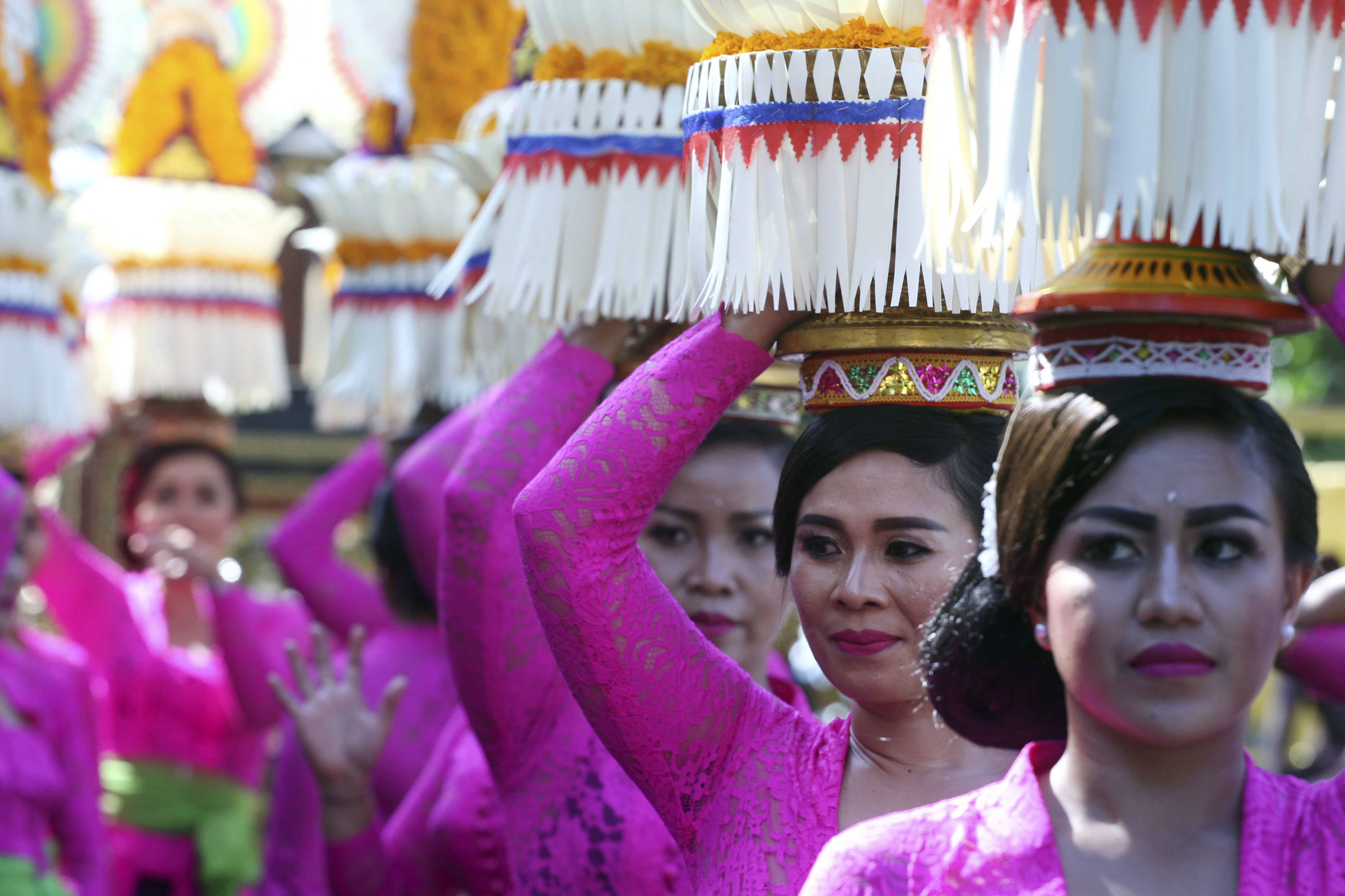 Balinese women in traditional dress line up during a parade of the Bali Arts Festival in Bali, Indonesia, Saturday, June 10, 2017. A month-long annual festival started on Saturday. (AP Photo/Firdia Lisnawati)
