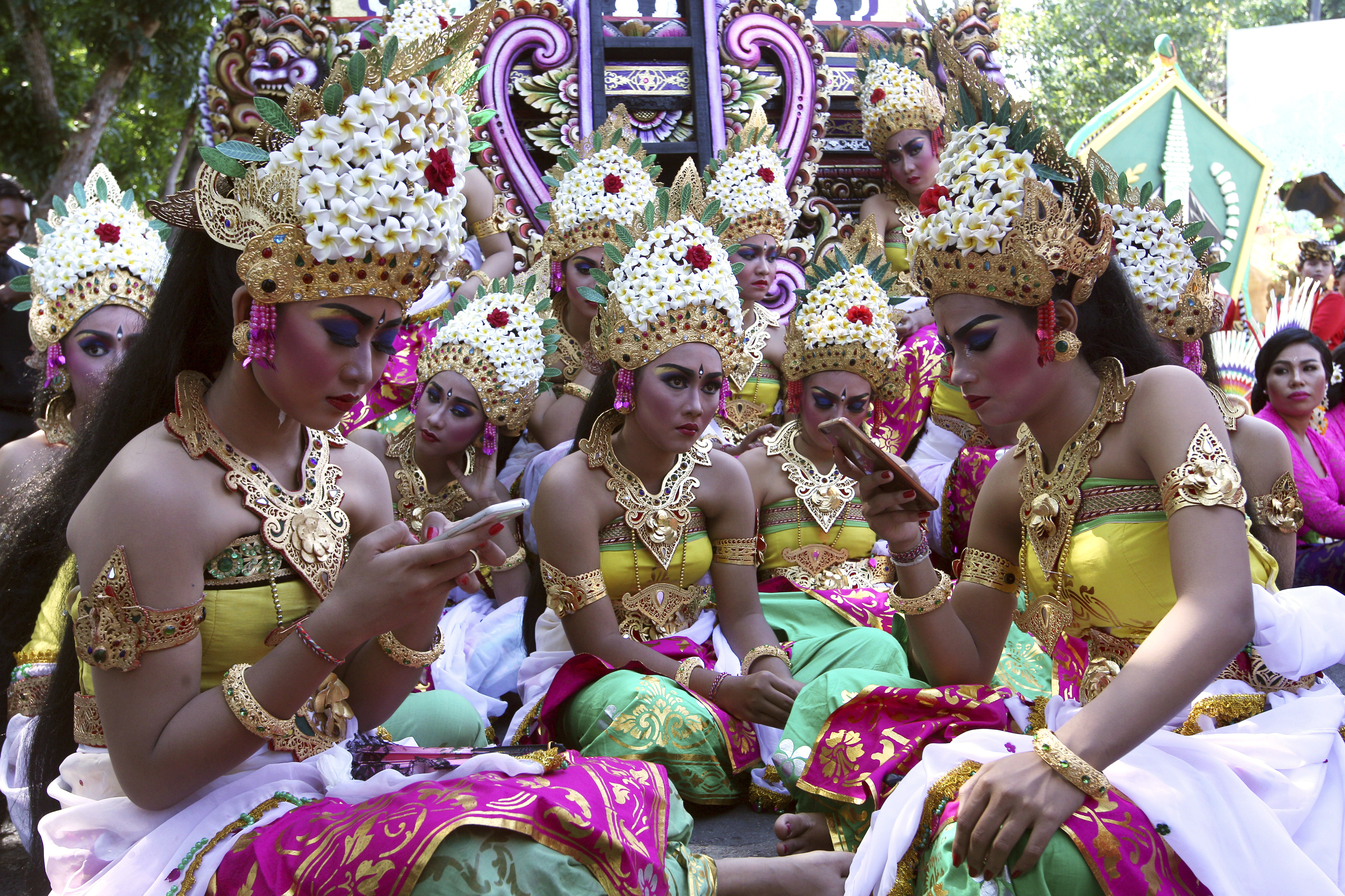 Dancers in traditional dress wait for a parade during the Bali Arts Festival in Bali, Indonesia, Saturday, June 10, 2017. A month-long annual festival started on Saturday. (AP Photo/Firdia Lisnawati)