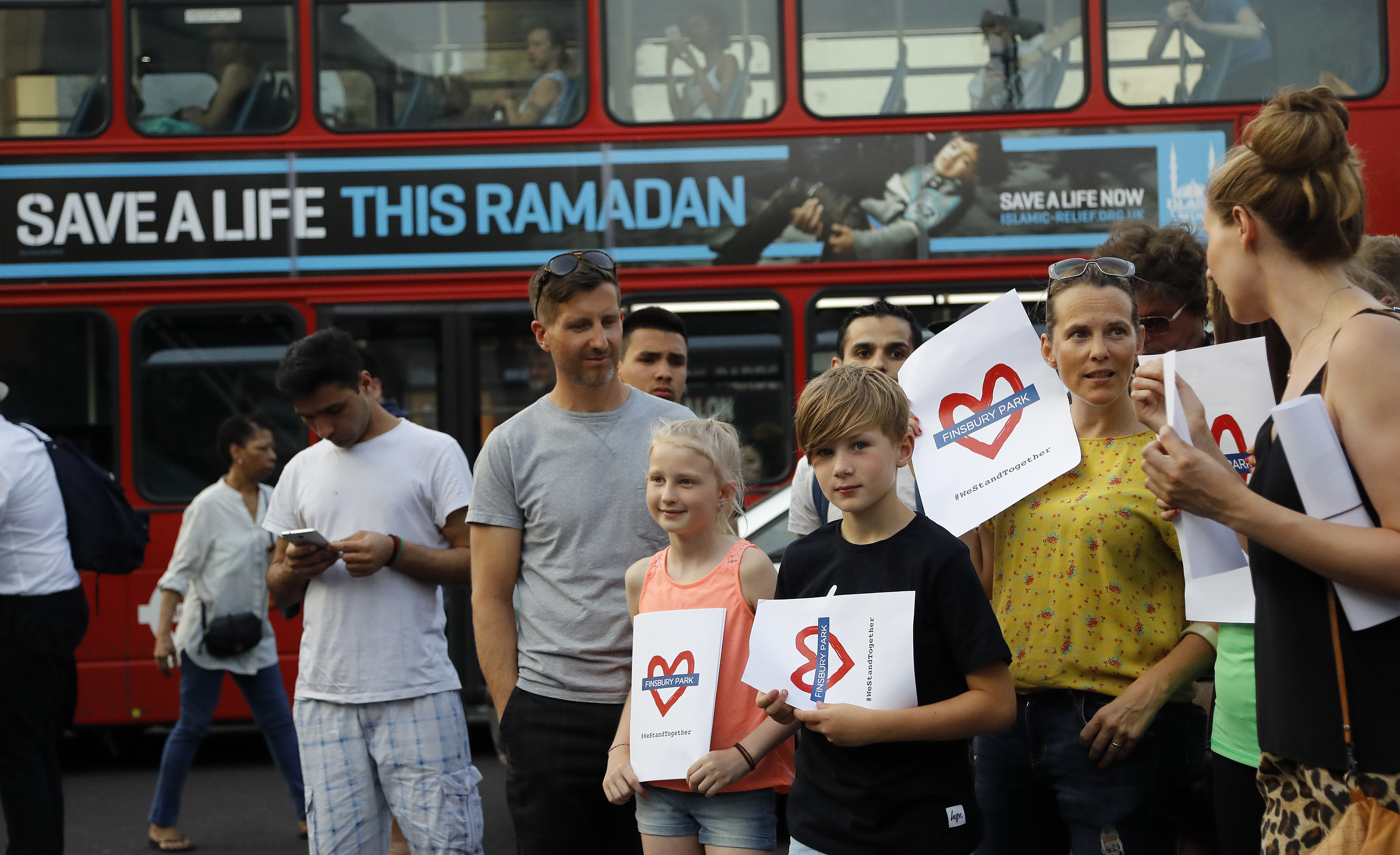 People take part in a vigil at Finsbury Park in north London, where a vehicle struck pedestrians in north London Monday, June 19, 2017. A vehicle struck pedestrians near a mosque in north London early Monday morning. (AP Photo/Frank Augstein)