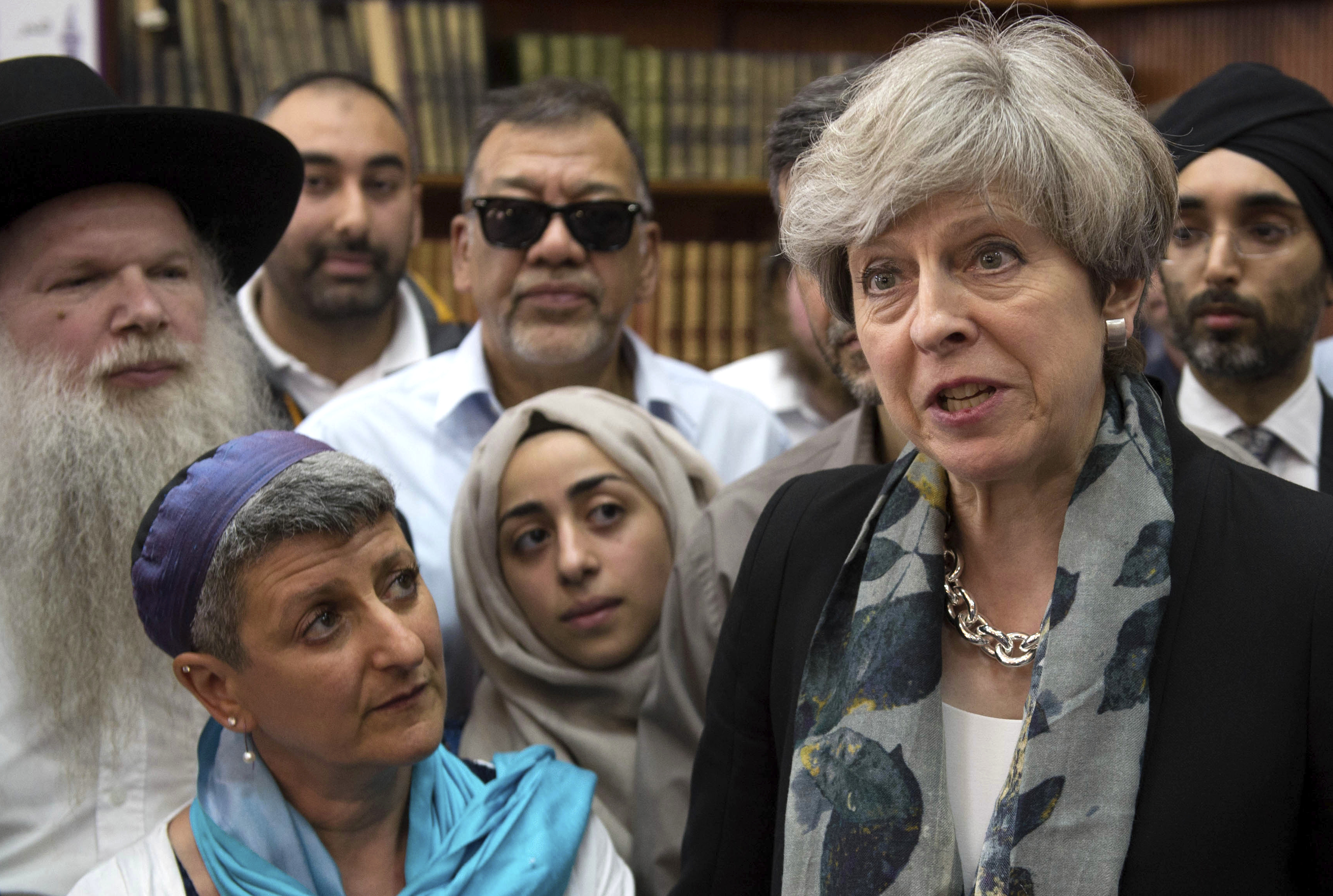 Britain's Prime Minister Theresa May, right, talk to faith leaders at Finsbury Park Mosque in north London, after an incident where where a van struck pedestrians, in London, Monday June 19, 2017. British authorities and Islamic leaders moved swiftly to ease concerns in the Muslim community after a man plowed his vehicle into a crowd of worshippers outside a north London mosque early Monday, injuring at least nine people.﻿﻿ (Stefan Rousseau/Pool Photo via AP)
