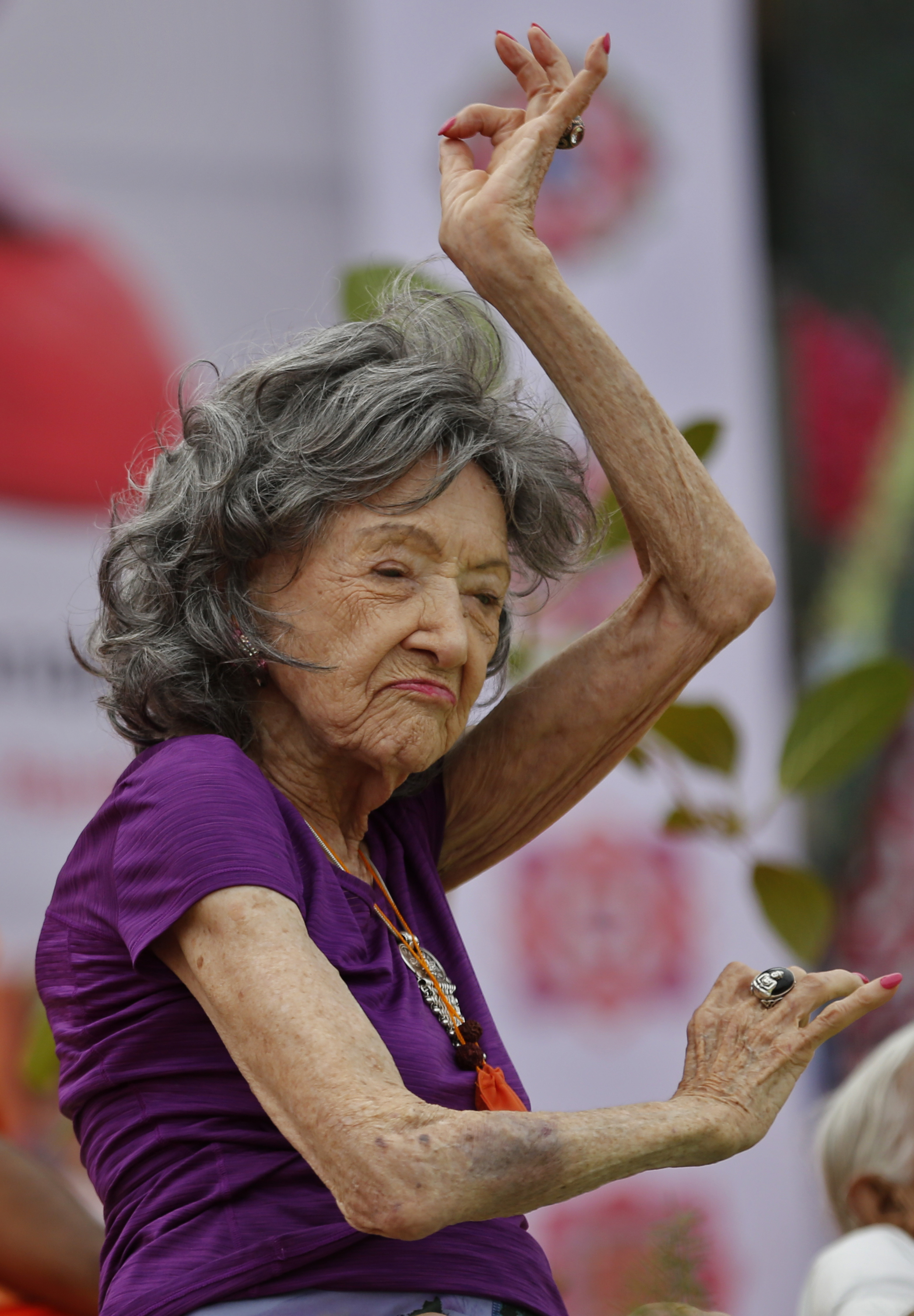 Yoga instructor, Tao Porchon-Lynch, 98, performs at a function to mark International Yoga Day in Bangalore, India, Wednesday, June 21, 2017. Yoga practitioners took a relaxing break to bend, twist and pose Wednesday morning for the annual event celebrating the practice, especially in the country where it began. (AP Photo/Aijaz Rahi)