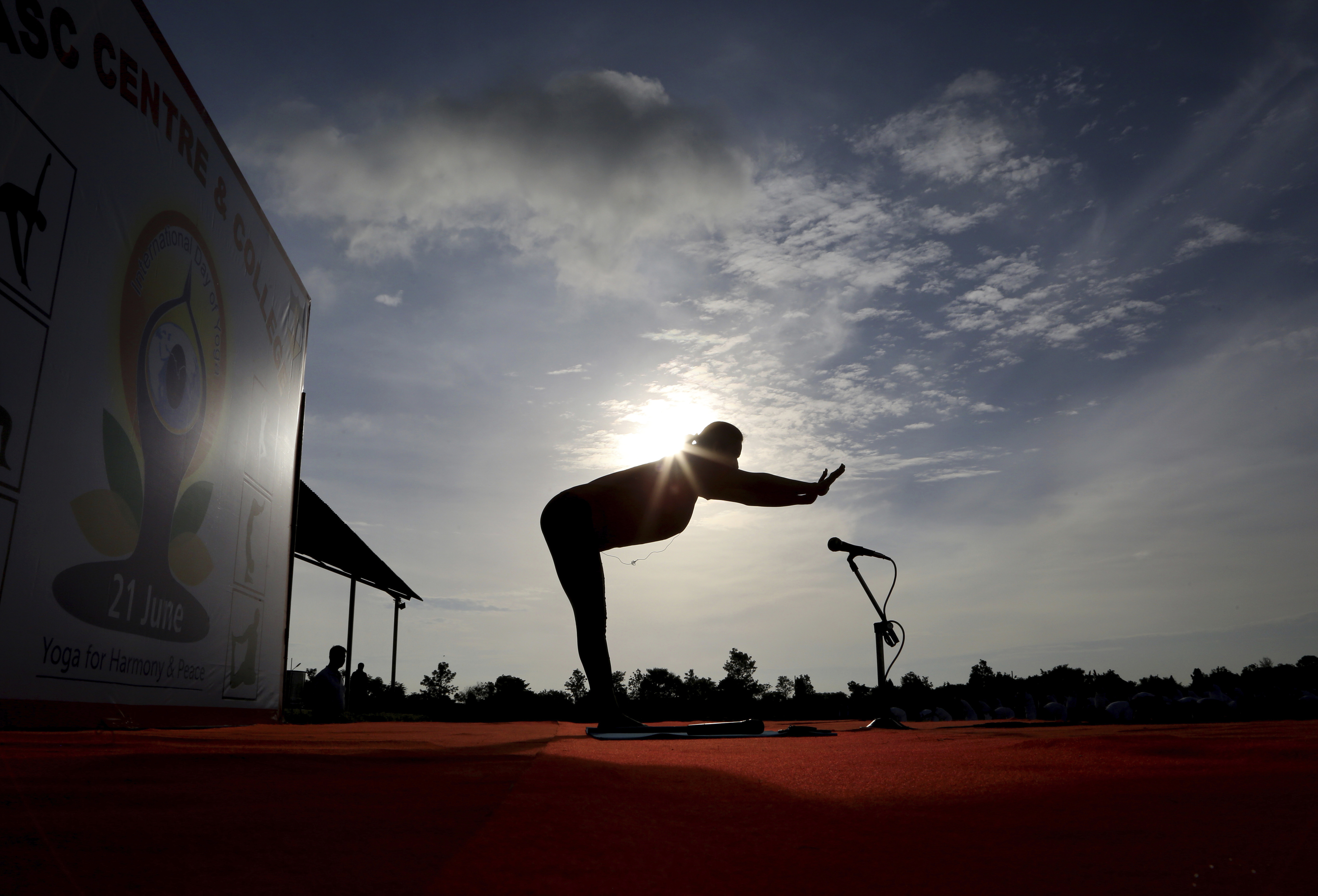 An Indian yoga instructor leads a large group of Indian army soldiers at a yoga session to mark International Yoga Day in Bangalore, India, Wednesday, June 21, 2017. Yoga practitioners took a relaxing break to bend, twist and pose Wednesday morning for the annual event celebrating the practice, especially in the country where it began. (AP Photo/Aijaz Rahi)