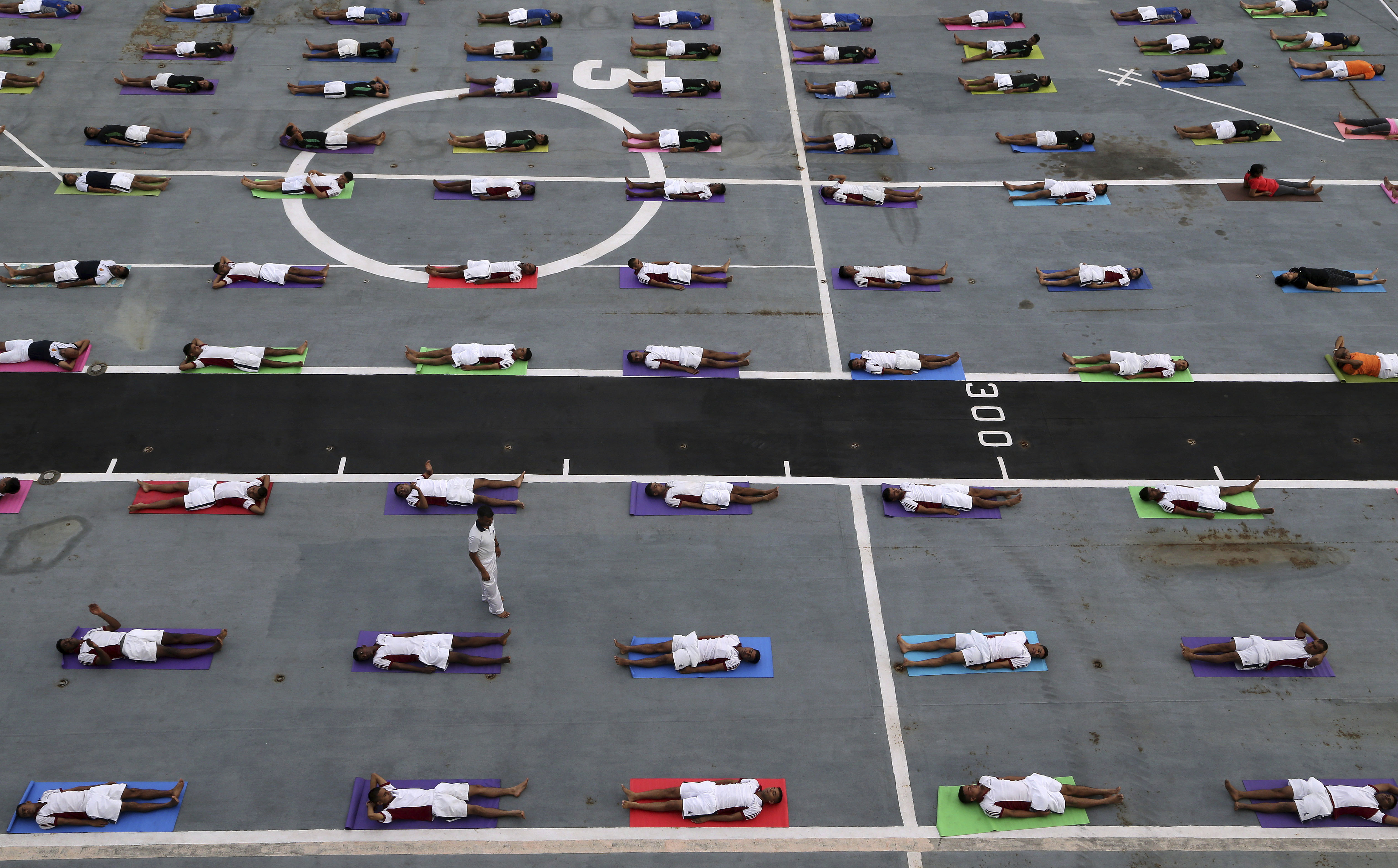 Indian armed forces and their families members perform Yoga on the deck of the Indian Naval aircraft carrier Viraat to mark International Yoga Day in Mumbai, India, Wednesday, June 21, 2017. Yoga practitioners took a relaxing break to bend, twist and pose Wednesday morning for the annual event celebrating the practice, especially in the country where it began. (AP Photo/Rajanish Kakade)