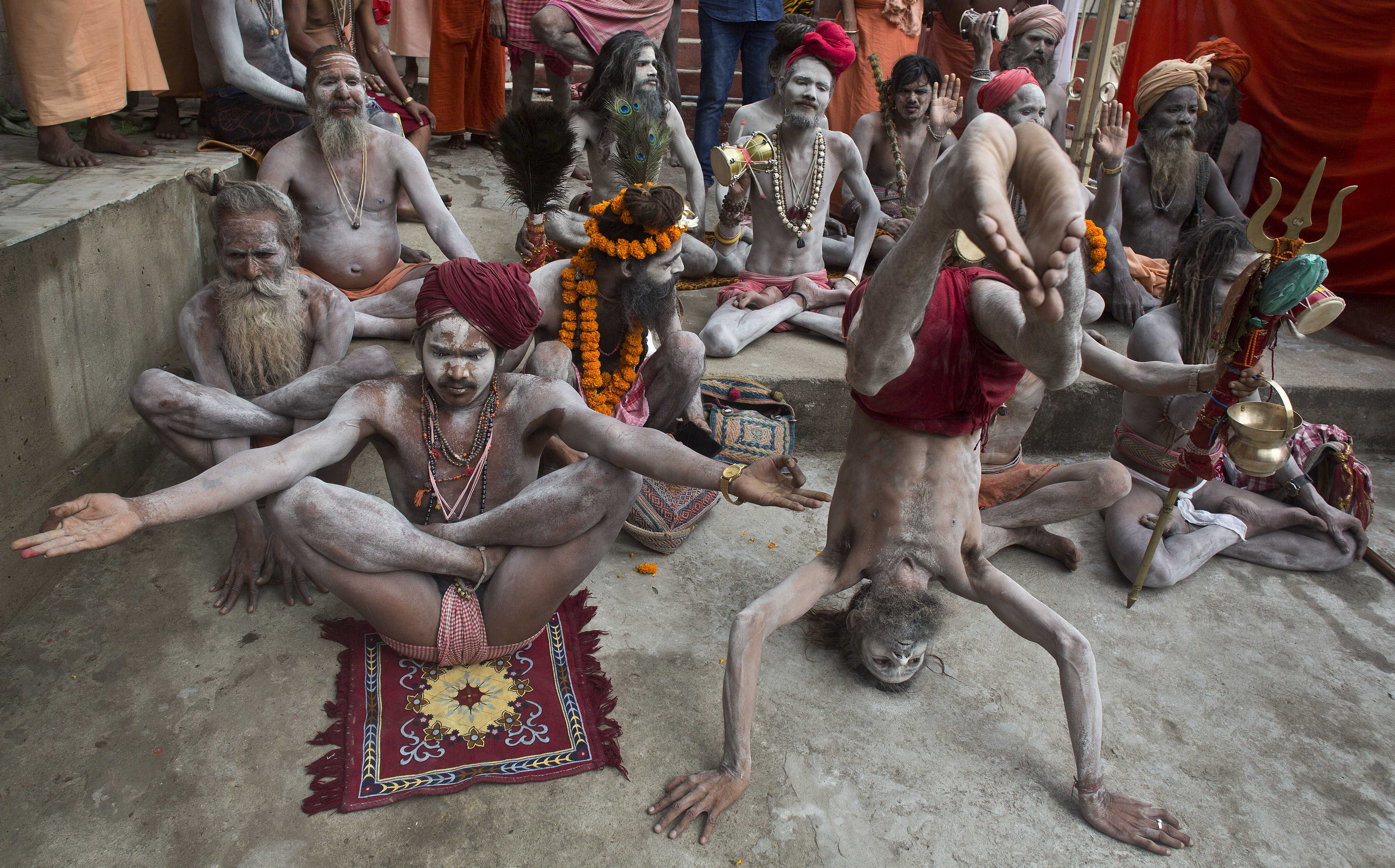 Indian Sadhus or Hindu holy men perform Yoga to mark the International Yoga Day at Kamakhya temple in Gauhati, India , Wednesday, June 21, 2017. Yoga practitioners took a relaxing break to bend, twist and pose Wednesday morning for the annual event celebrating the practice, especially in the country where it began. (AP Photo/Anupam Nath)
