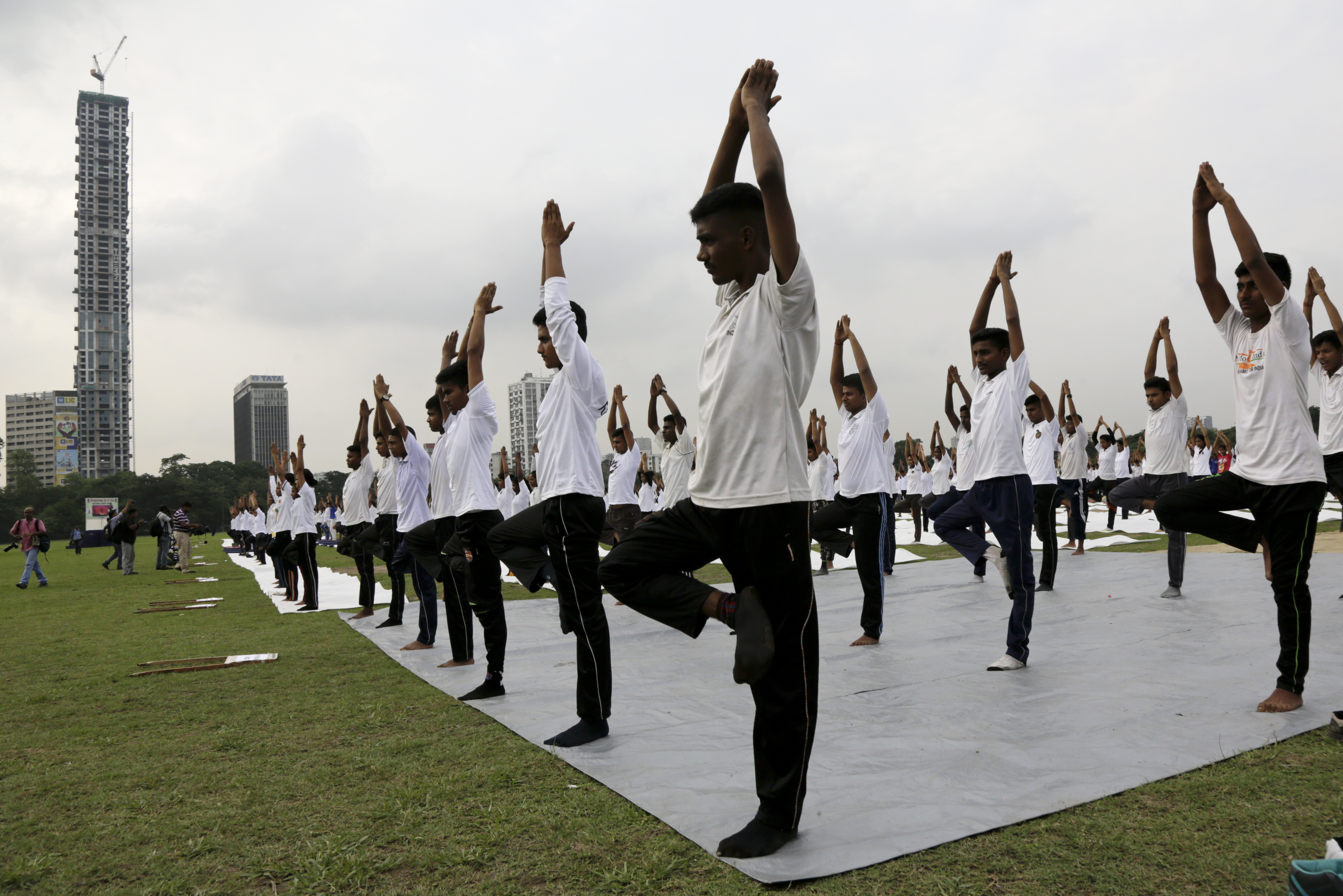 Indians perform Yoga to mark the International Yoga Day in Kolkata, India, Wednesday, June 21, 2017. Yoga practitioners took a relaxing break to bend, twist and pose Wednesday morning for the annual event celebrating the practice, especially in the country where it began. (AP Photo/Bikas Das)