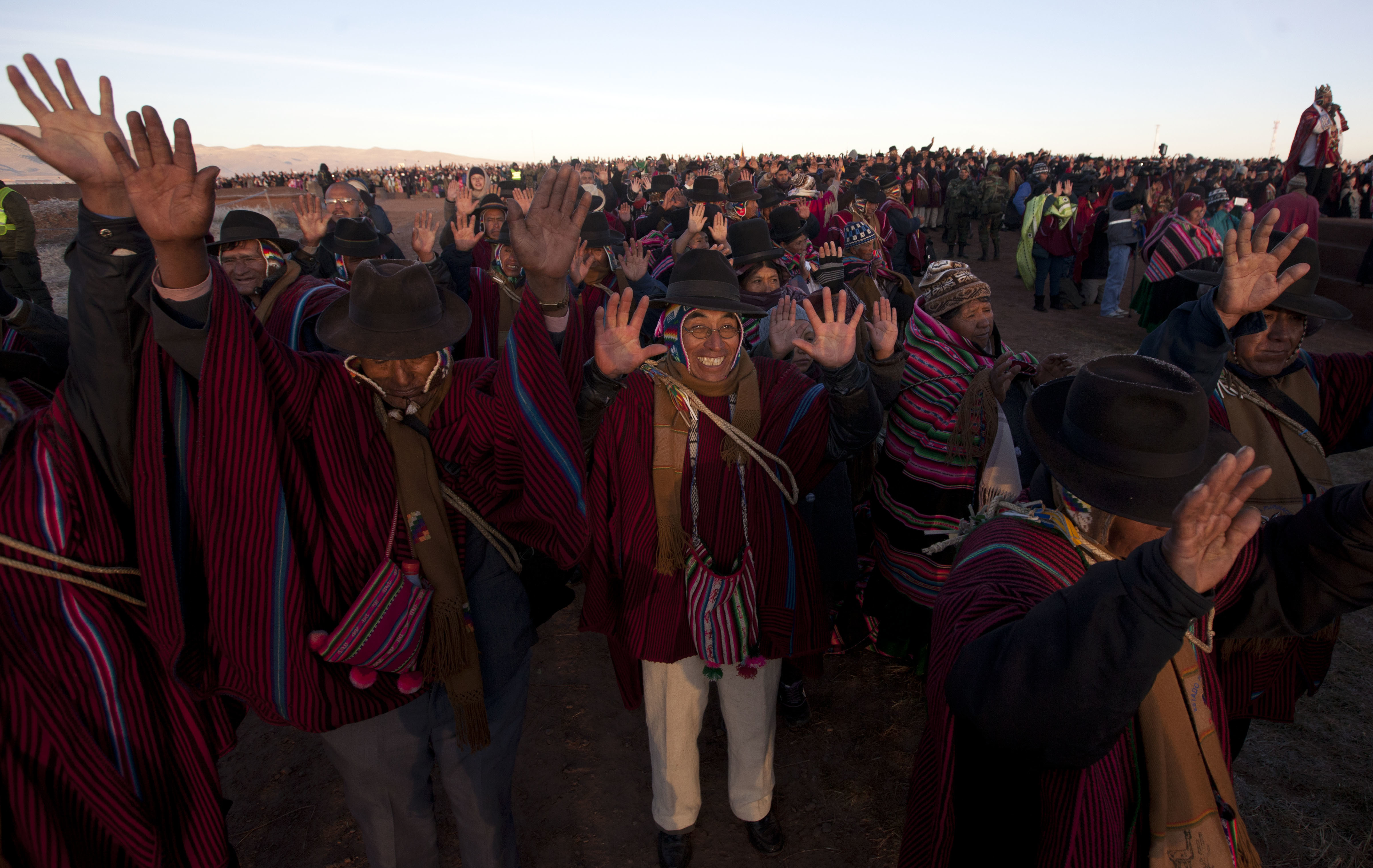 Aymara Indians hold up their hands to receive the first rays of sunlight in a New Year's ritual in the ruins of the ancient city Tiwanaku, Bolivia, early Wednesday, June 21, 2017. Bolivia's Aymara Indians are celebrating the year 5,525 as well as the Southern Hemisphere's winter solstice, which marks the start of a new agricultural cycle. (AP Photo/Juan Karita)