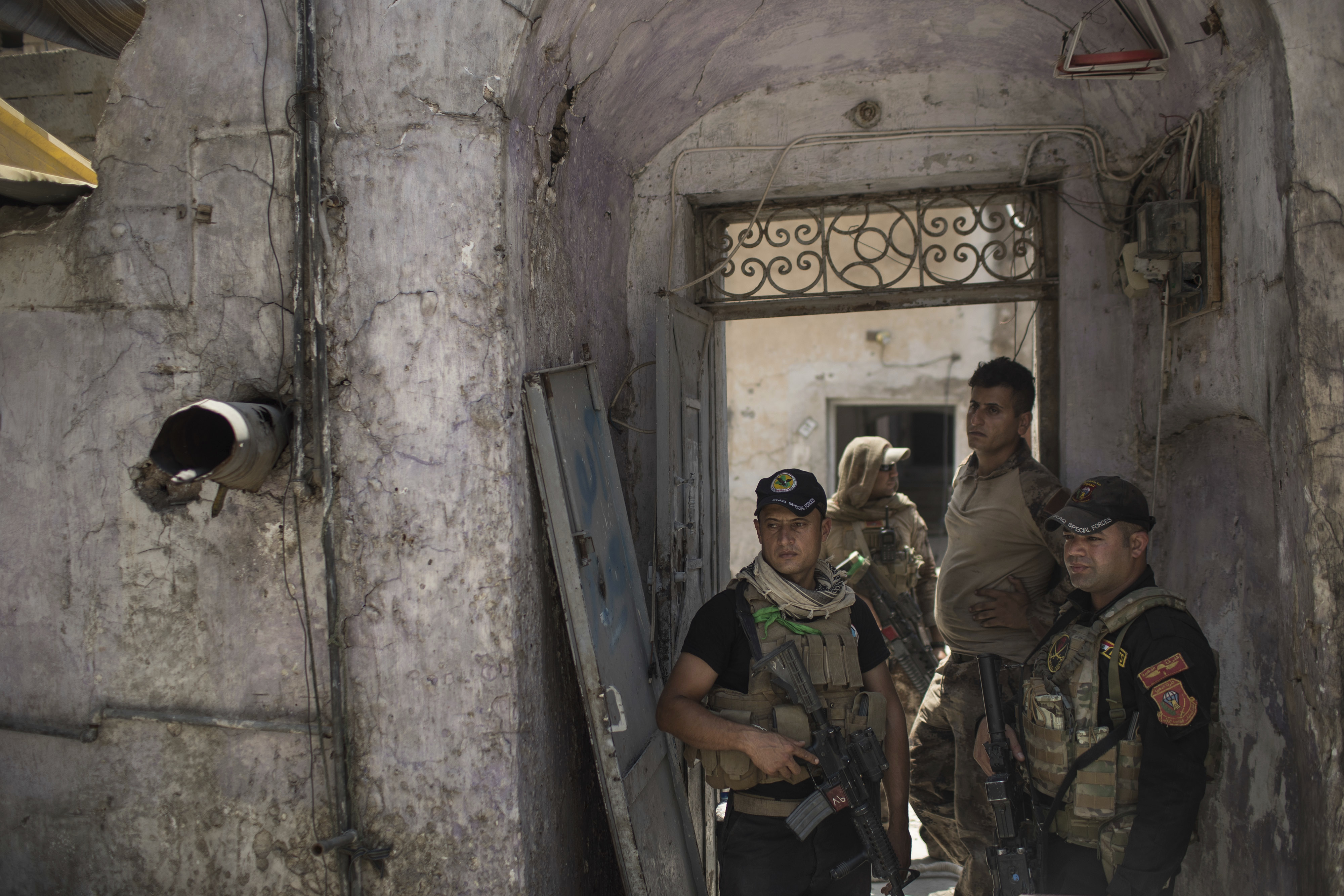Iraqi special forces soldiers stand in a house retaken by Iraqi forces during fighting against Islamic State militants in the Old City of Mosul, Iraq, Tuesday, June 27, 2017. An Iraqi officer says counterattacks by Islamic State militants on the western edge of Mosul have stalled Iraqi forces' push in the Old City _ the last IS stronghold in the city. (AP Photo/Felipe Dana)