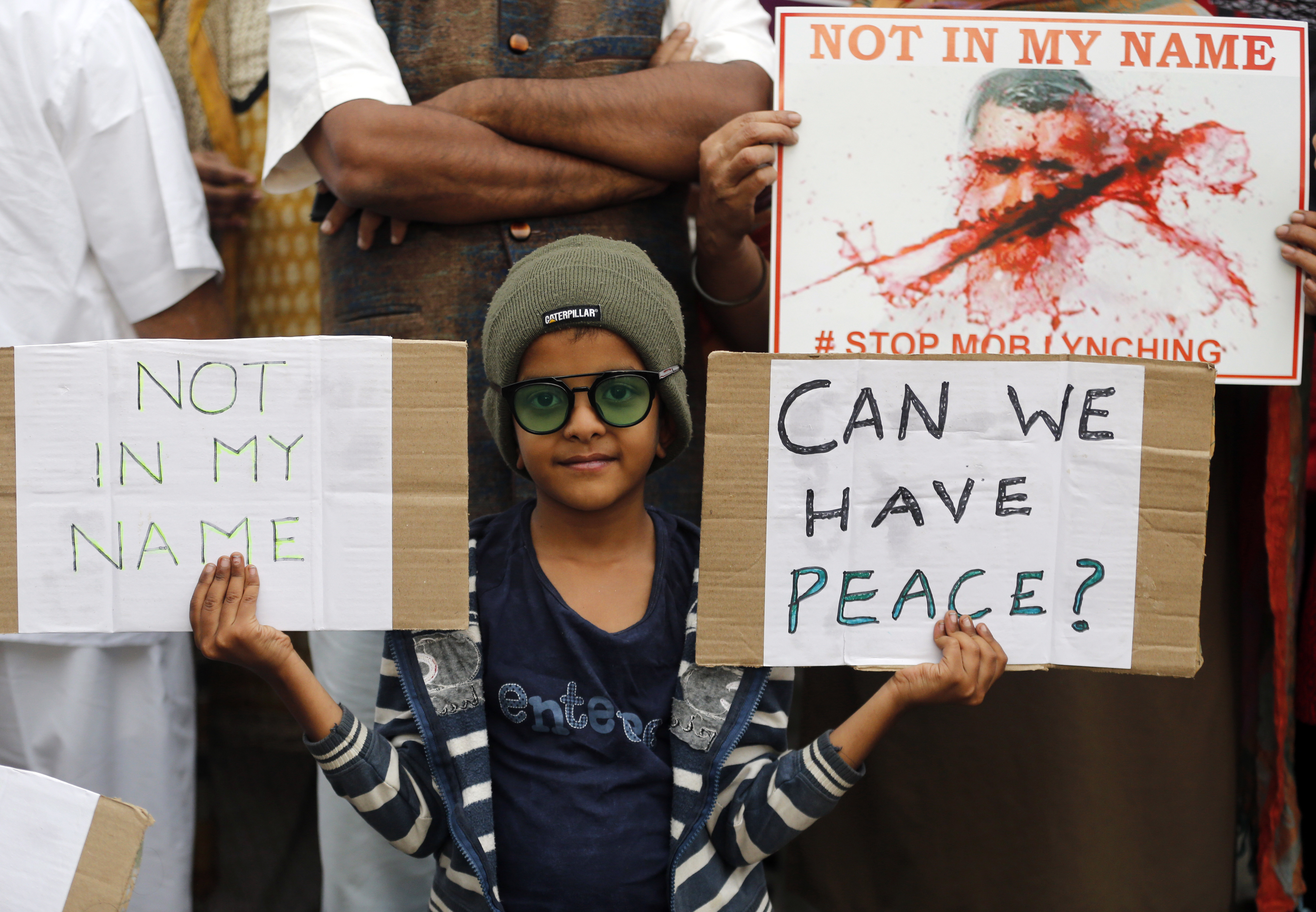 A boy holds placards during a protest against a spate of violent attacks across the country targeting the country's Muslim minority, in Bangalore, India, Wednesday, June 28, 2017. Thousands of protestors gathered in different cities to decry the silence of India's Hindu right-wing government in the face of the public lynchings and violent attacks on at least a dozen Muslim men and boys since it was voted to power in 2014. (AP Photo/Aijaz Rahi)