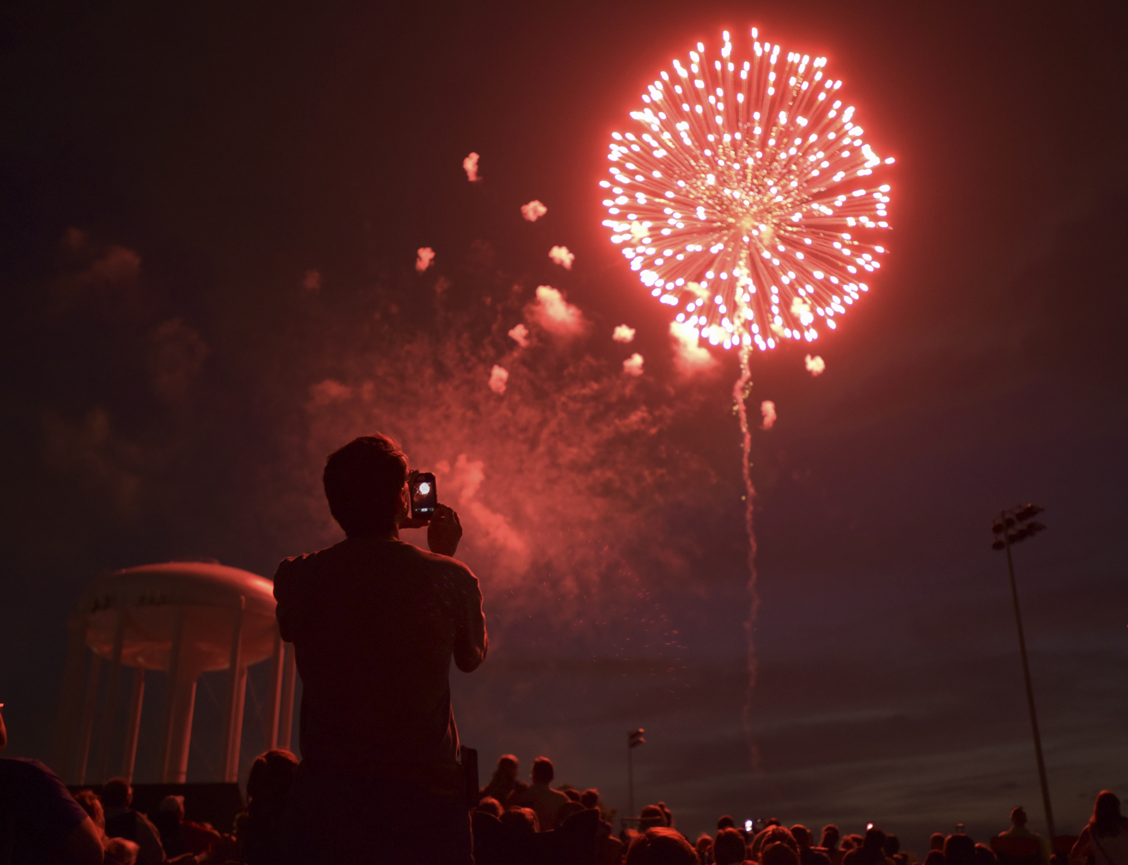 People watch fireworks at Graf Park over Wheaton, Ill., Monday July 3, 2017. (Mark Black/Daily Herald via AP)