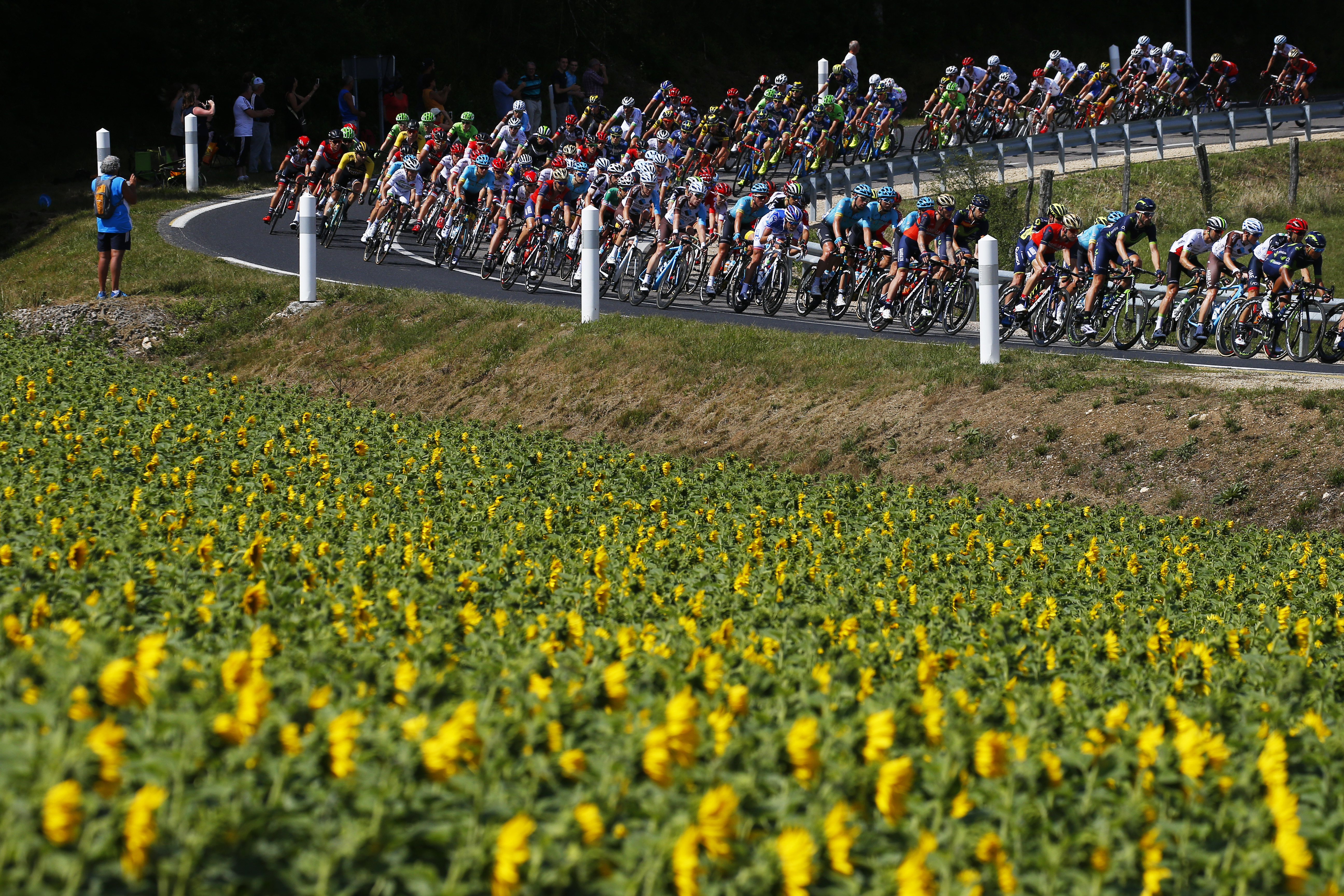 The pack speeds downhill during the fourth stage of the Tour de France cycling race over 207.5 kilometers (129 miles) with start in Mondorf-les-Bains, Luxembourg, and finish in Vittel, France, Tuesday, July 4, 2017. (AP Photo/Peter Dejong)