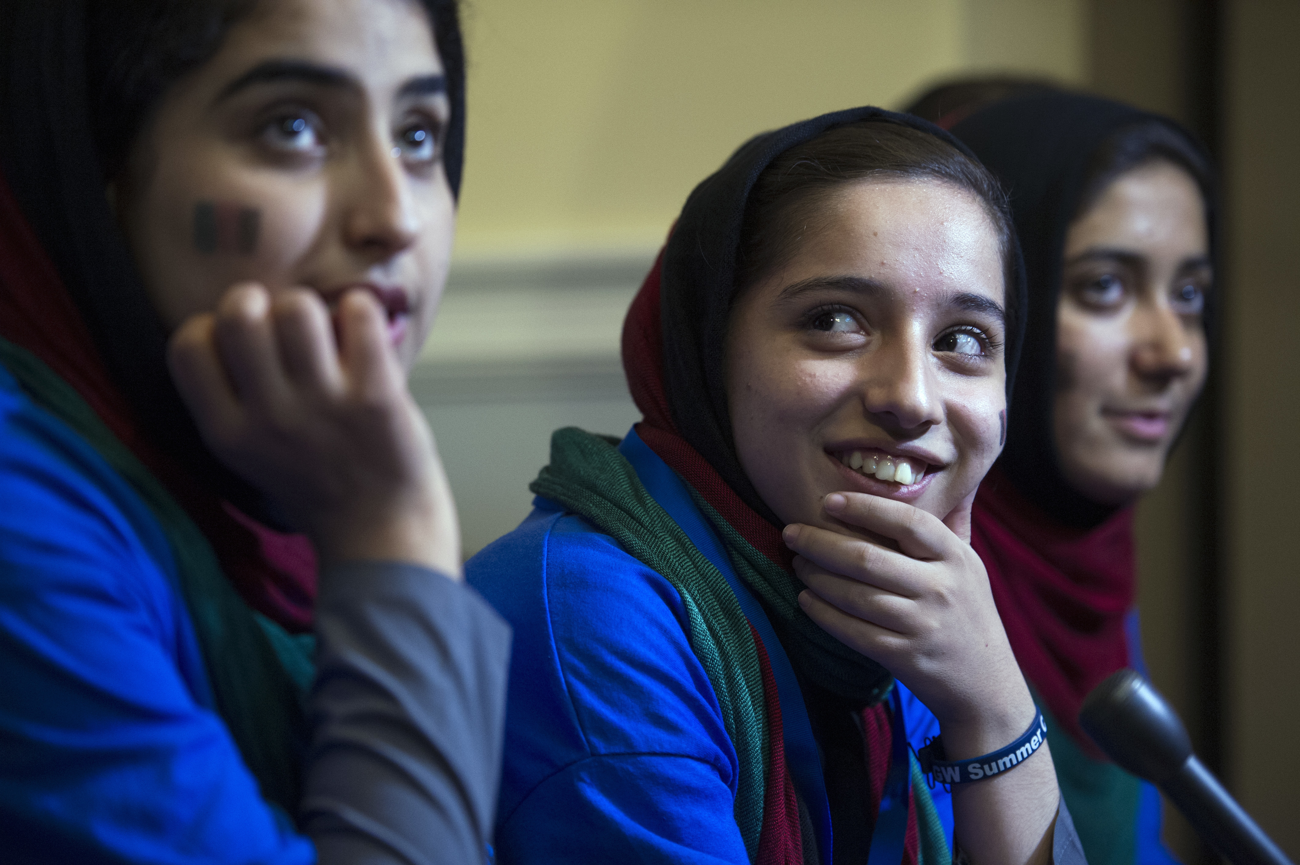 Afghanistan's FIRST Global Challenge team member Lida Azizi, from left, Fatemah Qaderyan, and Rodaba Noori meet with reporters following the opening ceremony in Washington, Sunday, July 16, 2017. Twice rejected for U.S. visas, the all-girls robotics team arrived in Washington on Saturday and will compete against entrants from more than 150 countries in the three-day high school competition. It's the first annual robotics competition designed to encourage youths to pursue careers in math and science. (AP Photo/Cliff Owen)