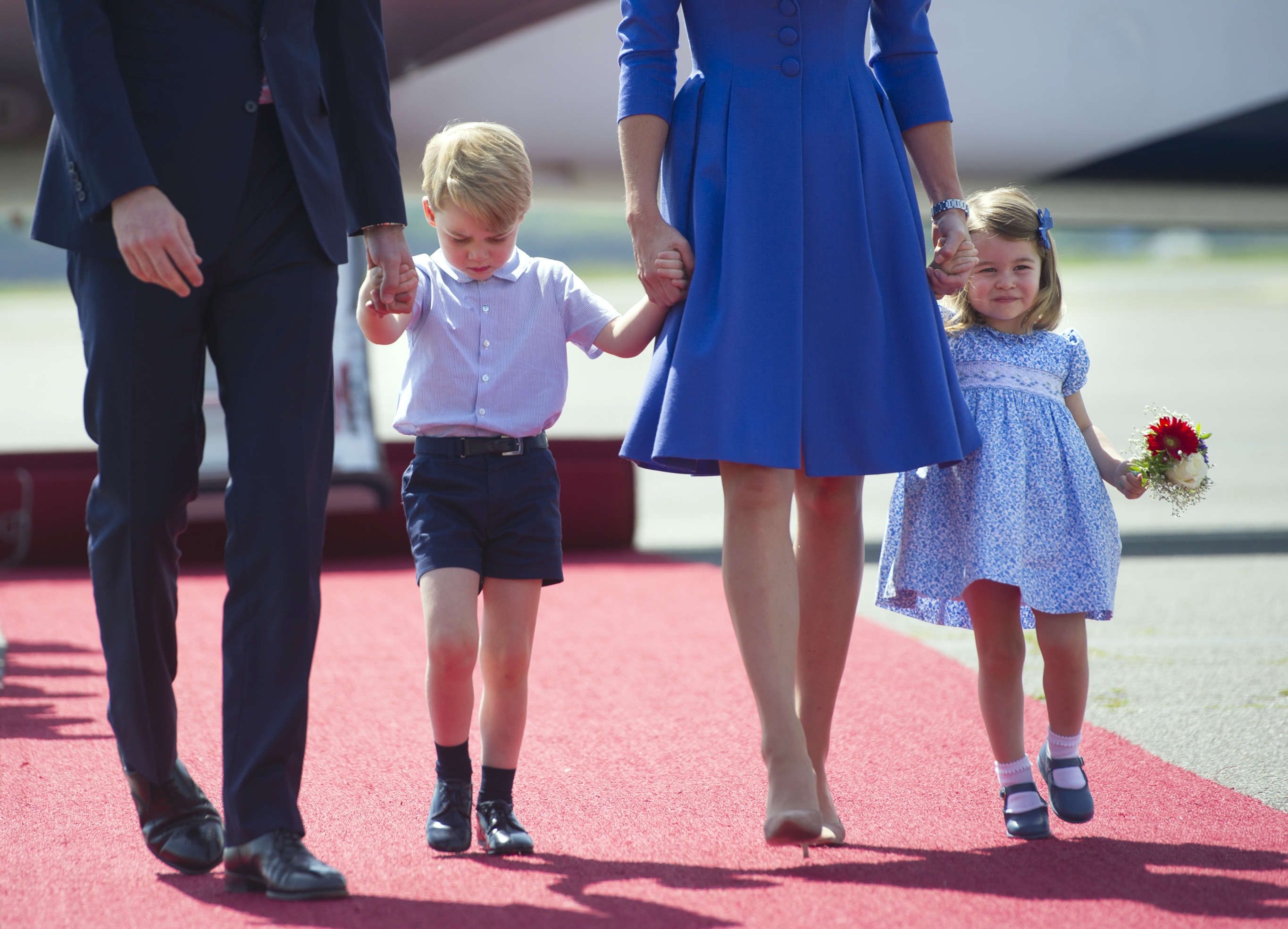 Britain's Prince William, left, Duke of Cambridge, Kate, the Duchess of Cambridge and their children Prince George, second left, and Princess Charlotte arrive at the airport in Berlin, Wednesday, July 19, 2017. The British royal couple is on a three-day-visit in Germany. (Steffi Loos/Pool Photo via AP)