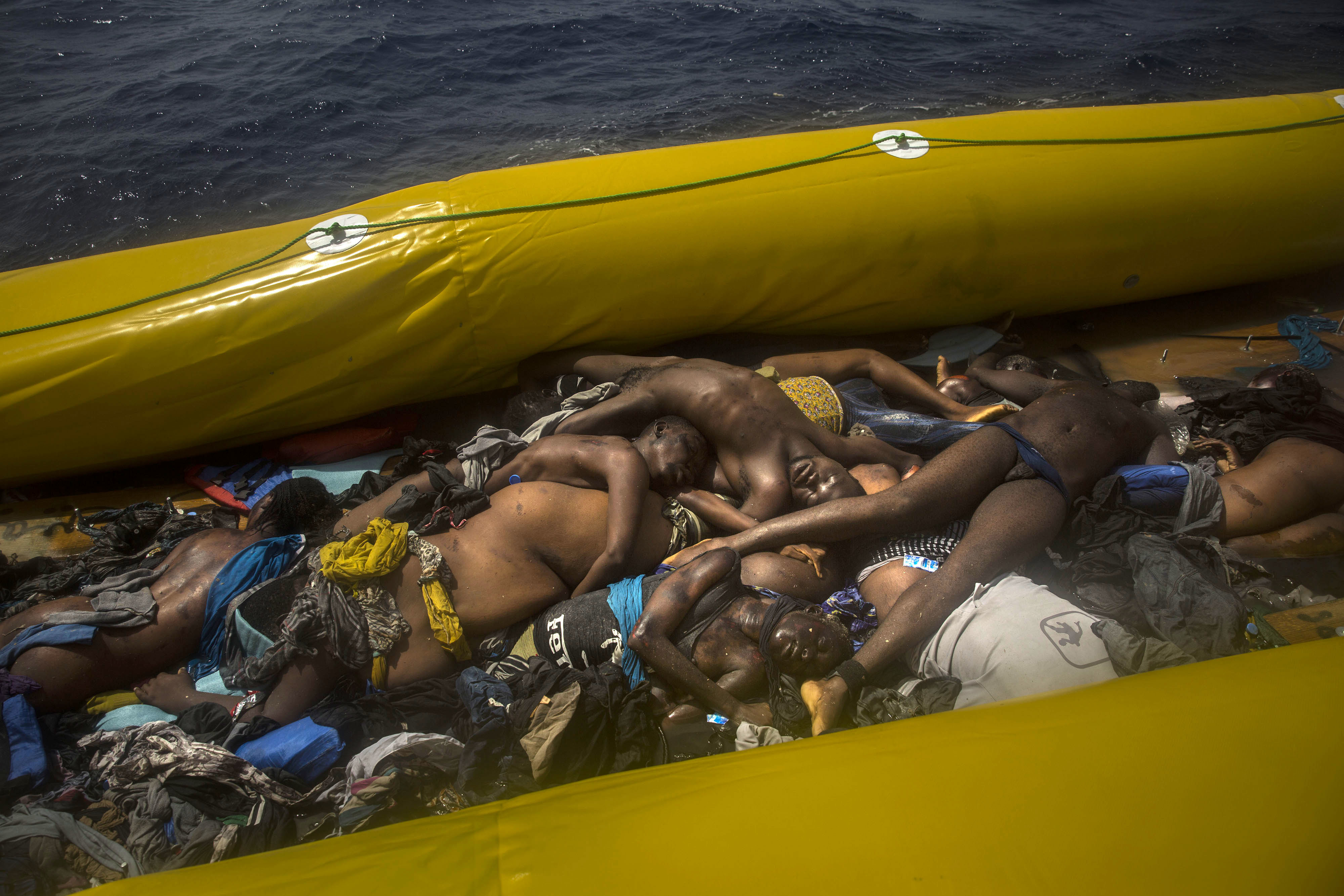 EDS NOTE: GRAPHIC CONTENT - Dead bodies of migrants are seen inside a rubber boat in the Mediterranean Sea, about 15 miles north of Sabratha, Libya on Tuesday, July 25, 2017. (AP Photo/Santi Palacios)