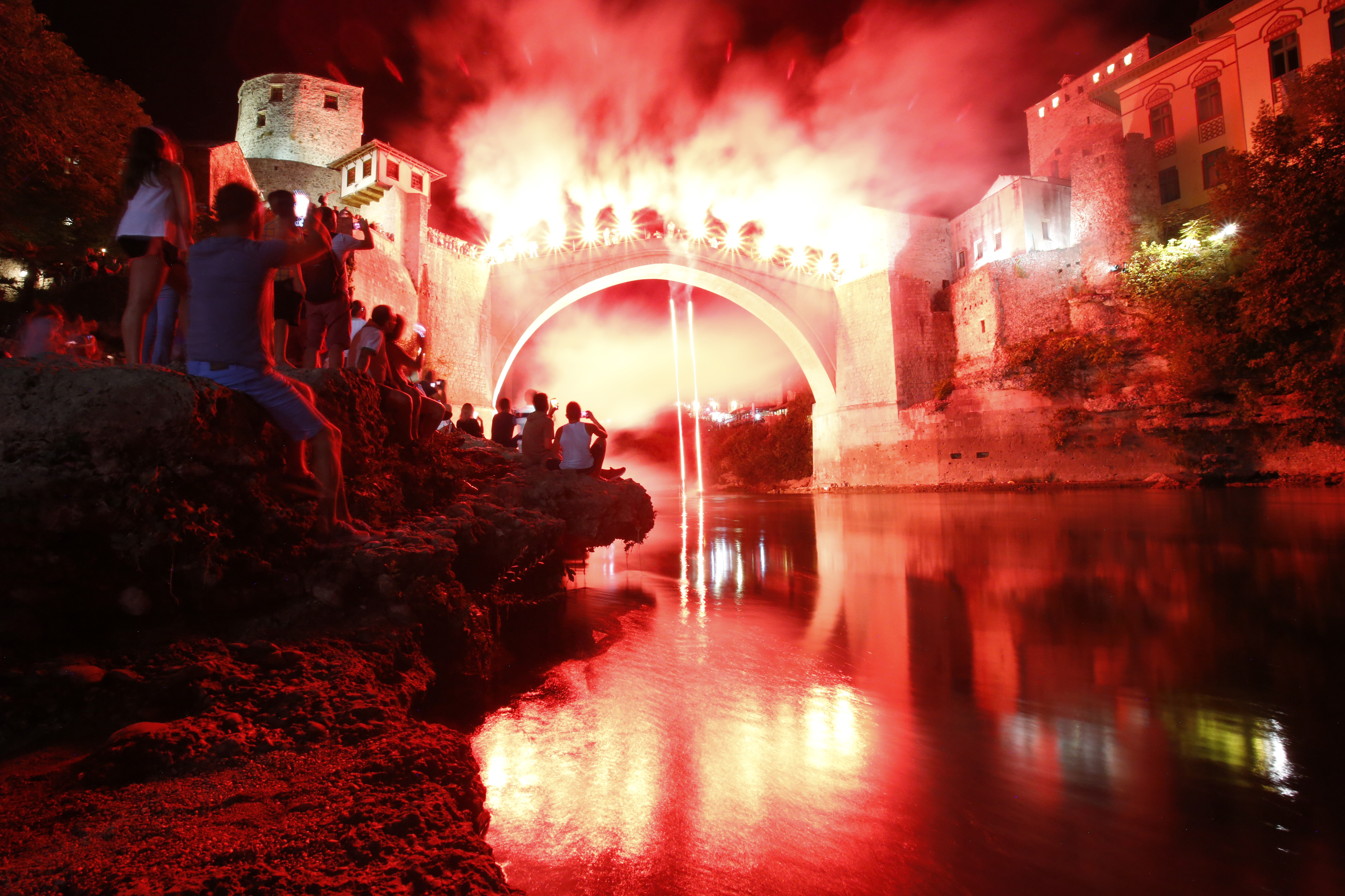 A Bosnian jumper, launches himself while holding burning torches, during traditional night jump from the Old Mostar Bridge, in Mostar, 140 kms south of Bosnian capital of Sarajevo, Sunday, July 30, 2017. A total of 41 divers from Bosnia and neighbouring countries competed diving from the 25 meter (82 feet) high Old Mostar Bridge into the Neretva River. (AP Photo/Amel Emric)