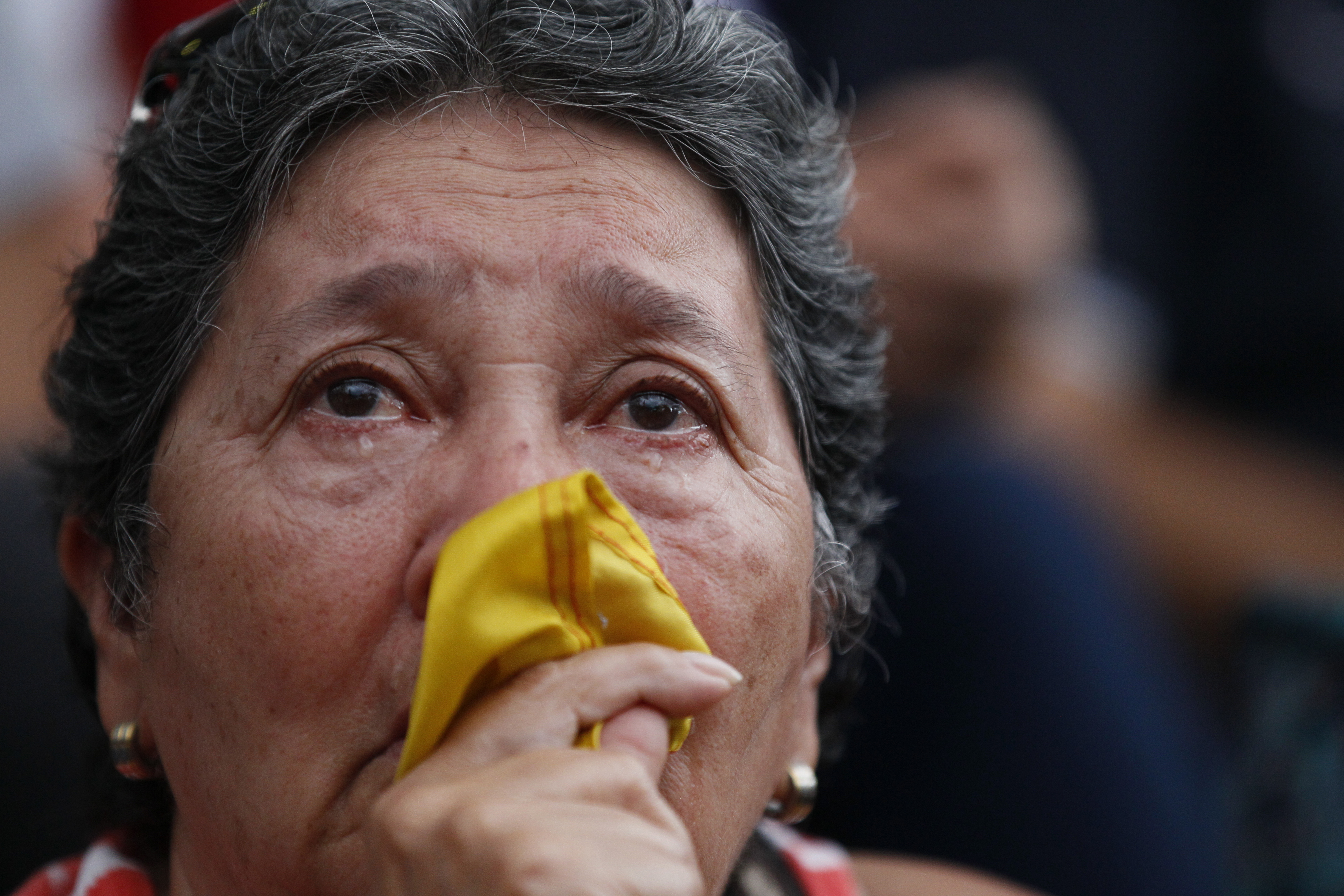 An anti-government demonstrator cries during a vigil in honor of those who have been killed during clashes between security forces and demonstrators in Caracas, Venezuela, Monday, July 31, 2017. Many analysts believe Sunday's vote for a newly elected assembly that will rewrite Venezuela’s constitution will catalyze yet more disturbances in a country that has seen four months of street protests in which at least 125 people have died. (AP Photo/Ariana Cubillos)