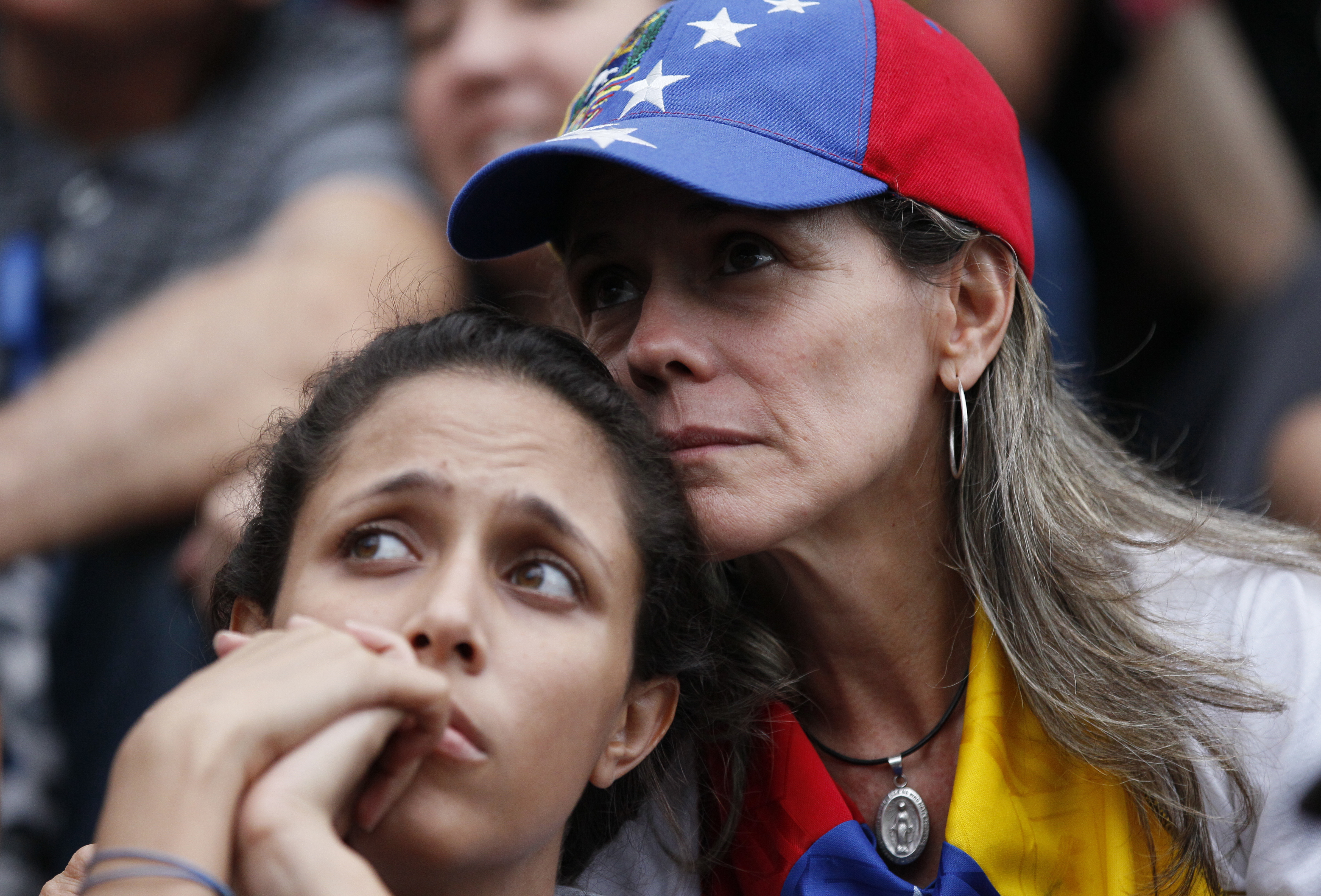 Anti-government demonstrators attend a vigil in honor of those who have been killed during clashes between security forces and demonstrators in Caracas, Venezuela, Monday, July 31, 2017. Many analysts believe Sunday's vote for a newly elected assembly that will rewrite Venezuela’s constitution will catalyze yet more disturbances in a country that has seen four months of street protests in which at least 125 people have died. (AP Photo/Ariana Cubillos)