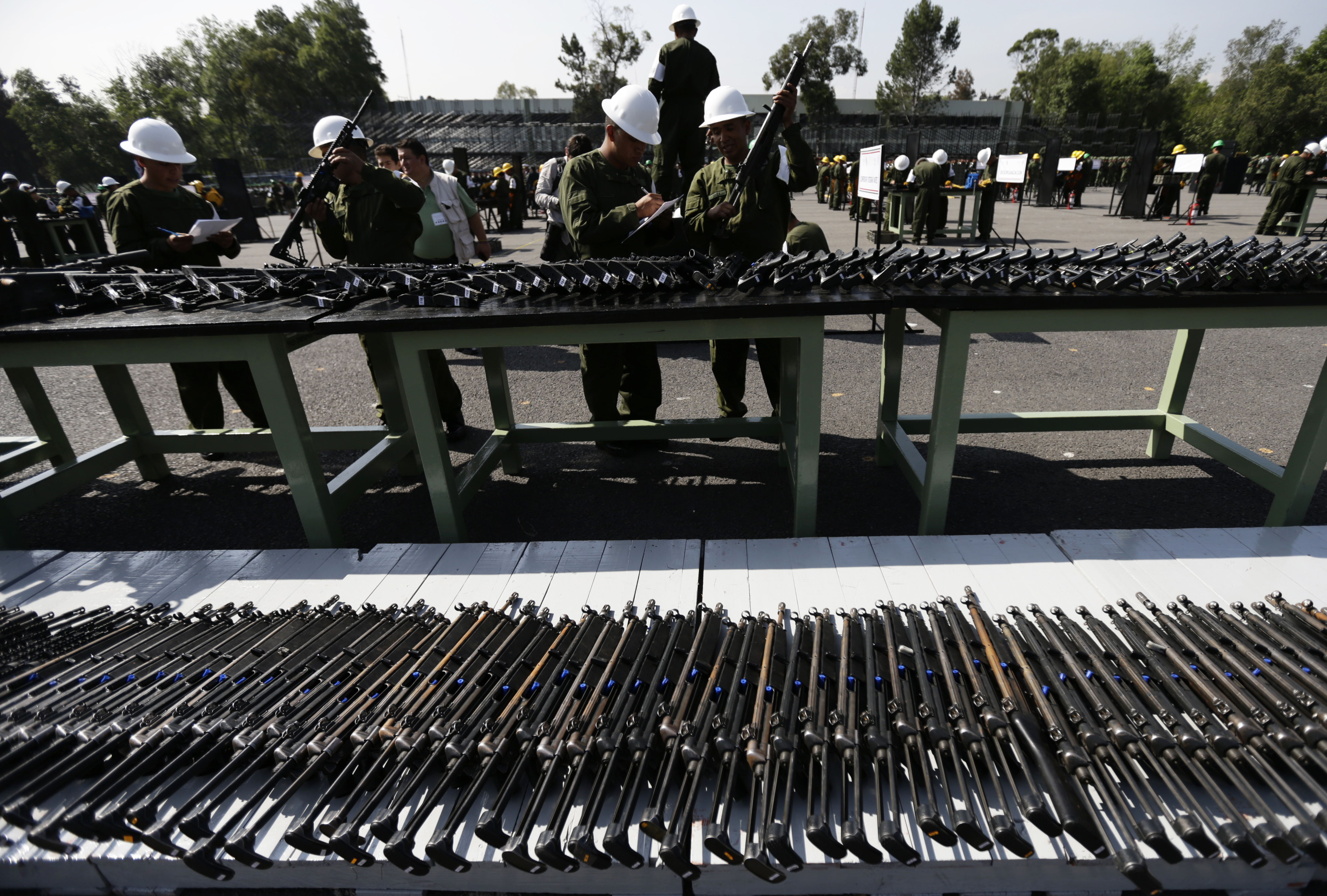 Weapons slated for destruction are displayed by the Mexican Army, in Mexico City, Tuesday, Aug. 1, 2017. The weapons were confiscated from organized crime and civilians who turned them in. (AP Photo/Marco Ugarte)