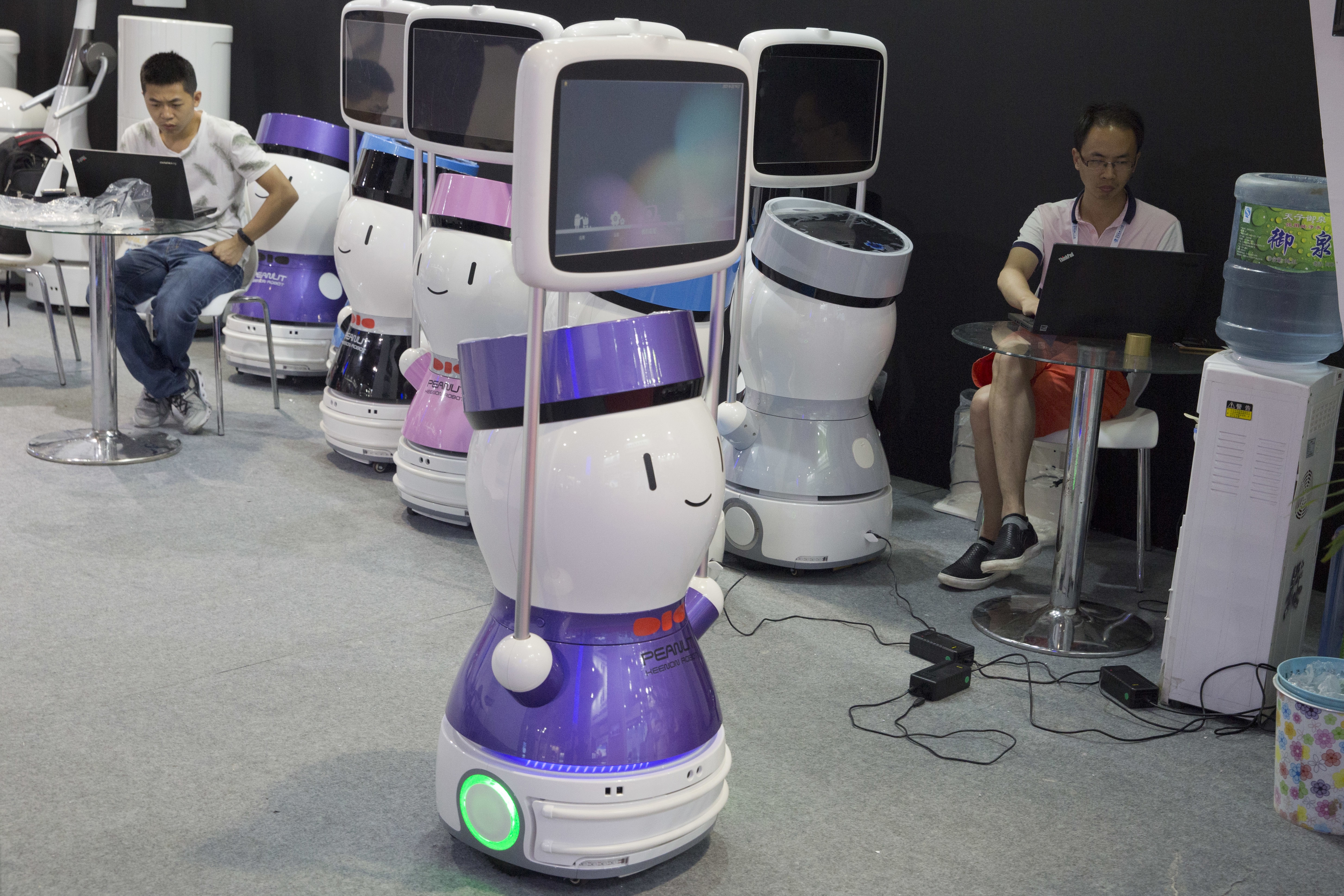 Engineers prepare robots a day before the opening of the World Robot Conference held in Beijing, China, Tuesday, Aug. 22, 2017. The annual conference is a showcase of China's burgeoning robot industry ranging from companion robots to those deployed on manufacturing assembly line and entertainment. (AP Photo/Ng Han Guan)