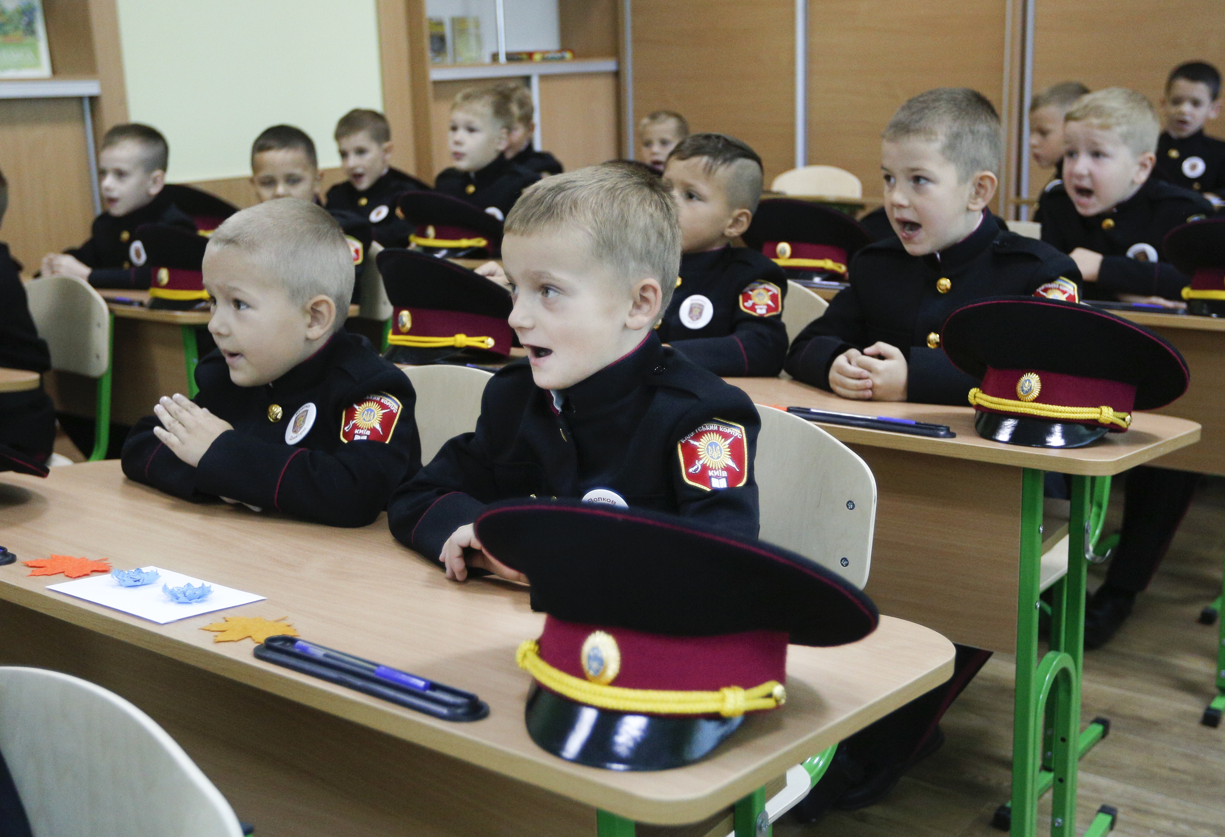 Young cadets listen to teacher at a the first lesson in a cadet lyceum of the first day at school in Kiev, Ukraine, Friday, Sept. 1, 2017. Ukraine marks Sept. 1 as Knowledge Day, as a traditional launch of the academic year. (AP Photo/Efrem Lukatsky)