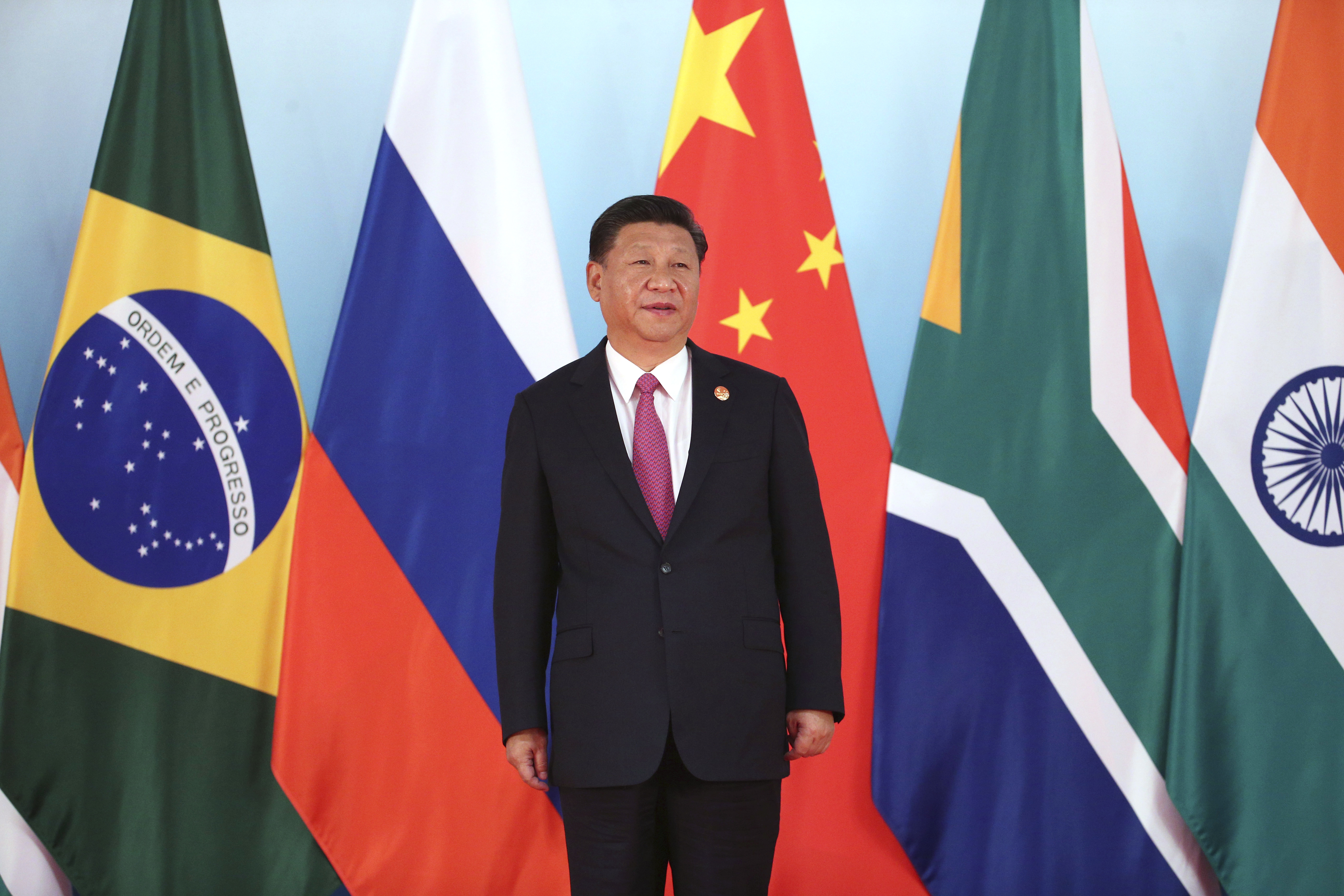 Chinese President Xi Jinping waits for other leaders for a group photo during the BRICS Summit at the Xiamen International Conference and Exhibition Center in Xiamen, southeastern China's Fujian Province, Monday, Sept. 4, 2017. (Wu Hong/Pool Photo via AP)