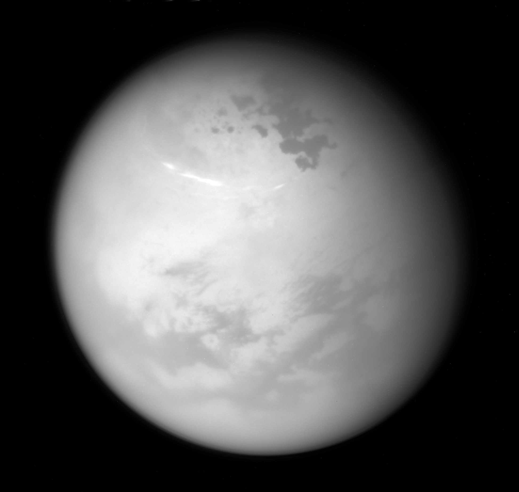 This  June 9, 2017 image made available by NASA shows bright methane clouds drifting in the summer skies of Saturn's moon Titan, along with dark hydrocarbon lakes and seas clustered around the north pole, as seen from the Cassini spacecraft. (NASA/JPL-Caltech/Space Science Institute via AP)