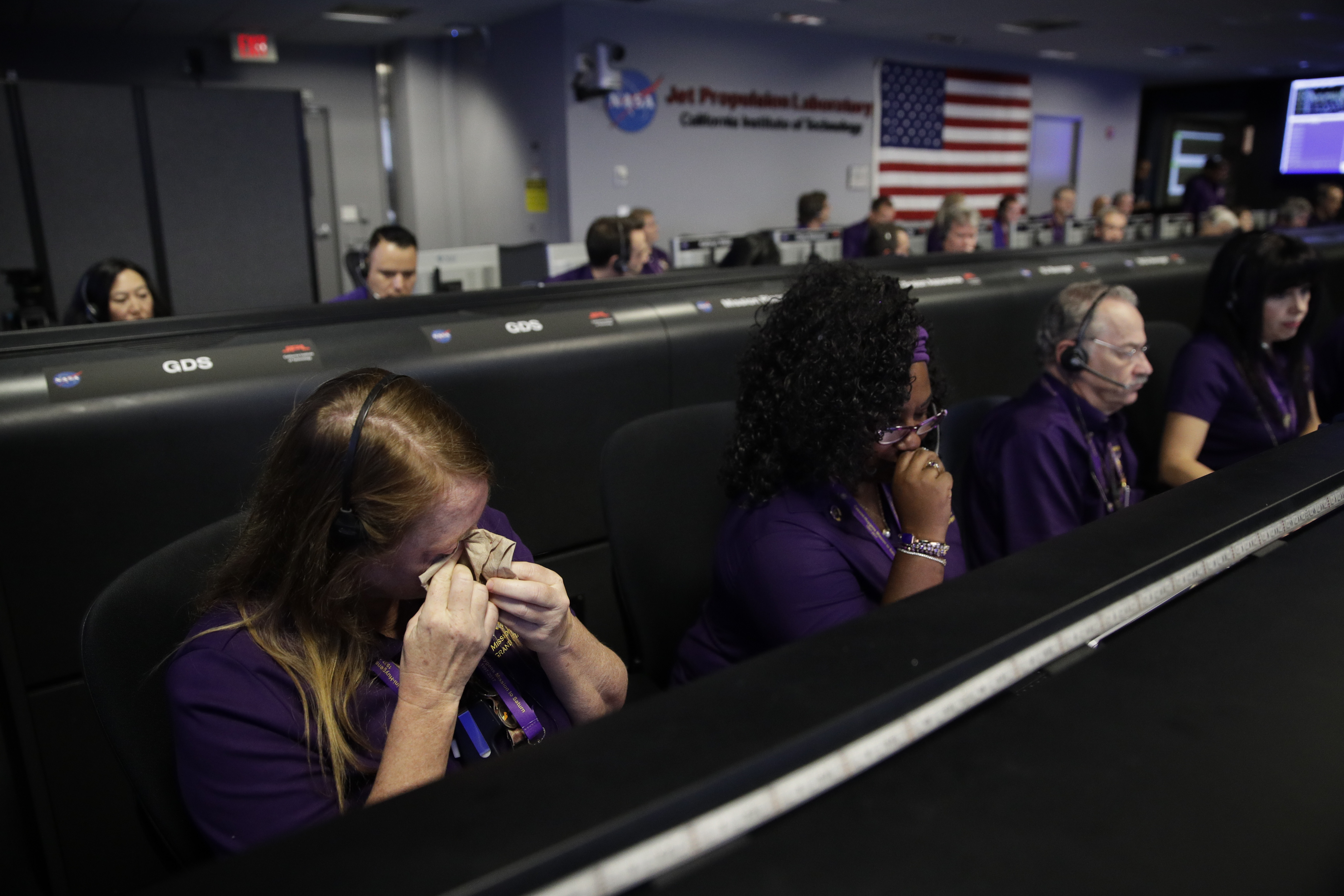 Engineer Nancy Vandermay, left, wipes her tears in mission control at NASA's Jet Propulsion Laboratory after confirmation of Cassini's demise Friday, Sept. 15, 2017, in Pasadena , Calif. Cassini disintegrated in the skies above Saturn early Friday, following a remarkable journey of 20 years. (AP Photo/Jae C. Hong, Pool)