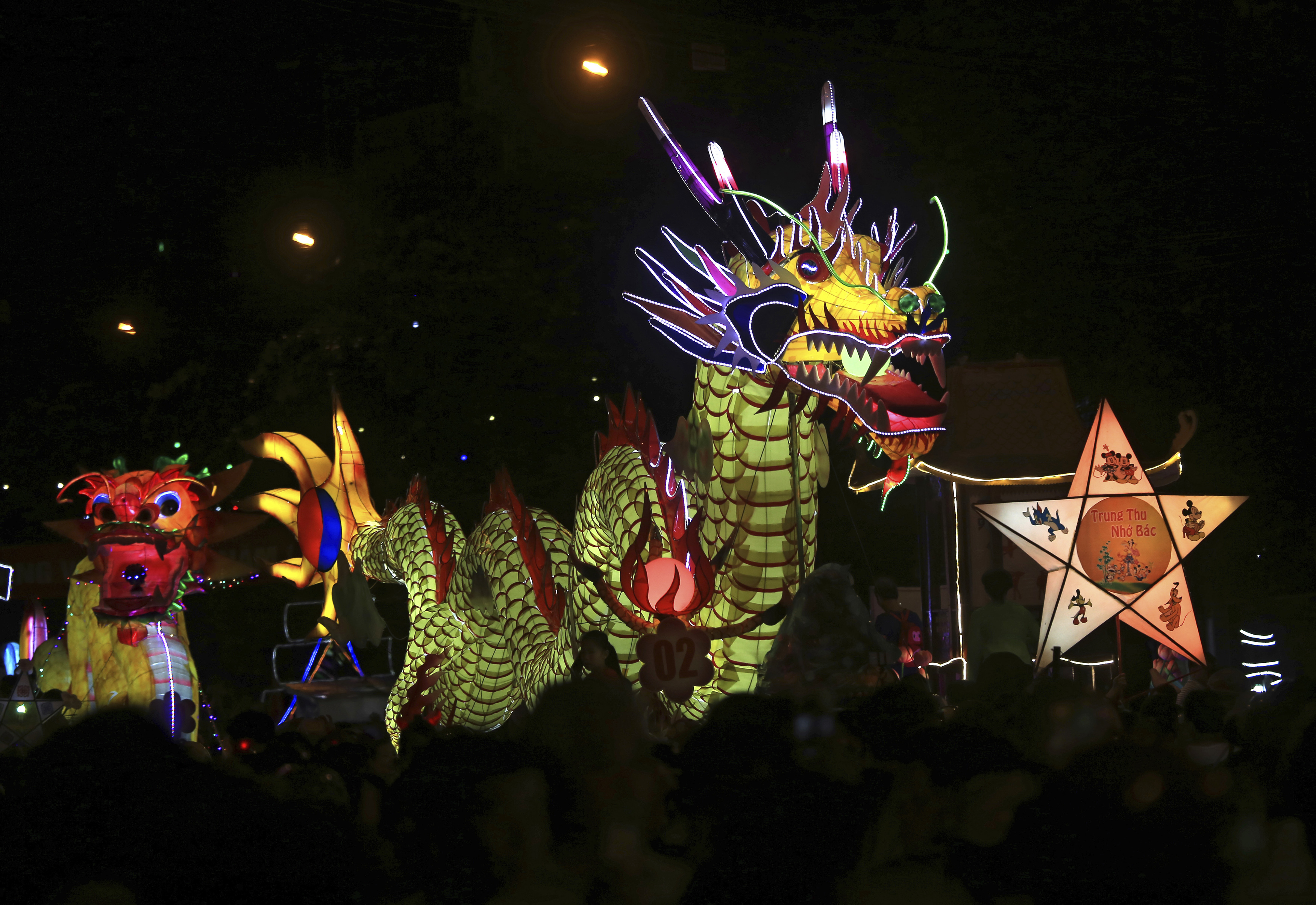 Dragon lantern floats parade through the streets to celebrate the Mid-Autumn, or Moon festival in Tuyen Quang city, Vietnam, Monday, Oct. 2, 2017. (AP Photo/Hau Dinh)