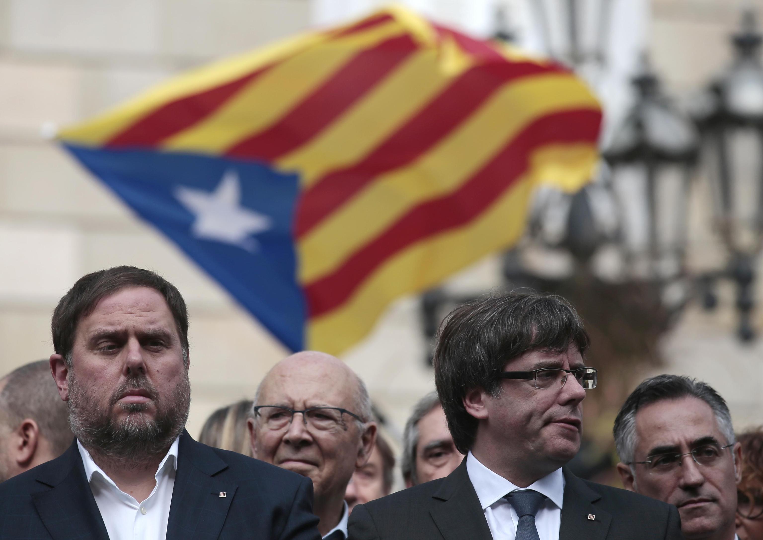 Catalan regional Vice-President, Oriol Junqueras, left, and Catalan President, Carles Puigdemont, attend during a protest called by pro-independence outside of the Palau Generalitat in Barcelona, Spain, Monday, Oct. 2, 2017. Catalonia's government will hold a closed-door Cabinet meeting Monday to discuss the next steps in its plan to declare independence from Spain following a disputed referendum marred by violence. (ANSA/AP Photo/Manu Fernandez) [CopyrightNotice: Copyright 2017 The Associated Press. All rights reserved.]
