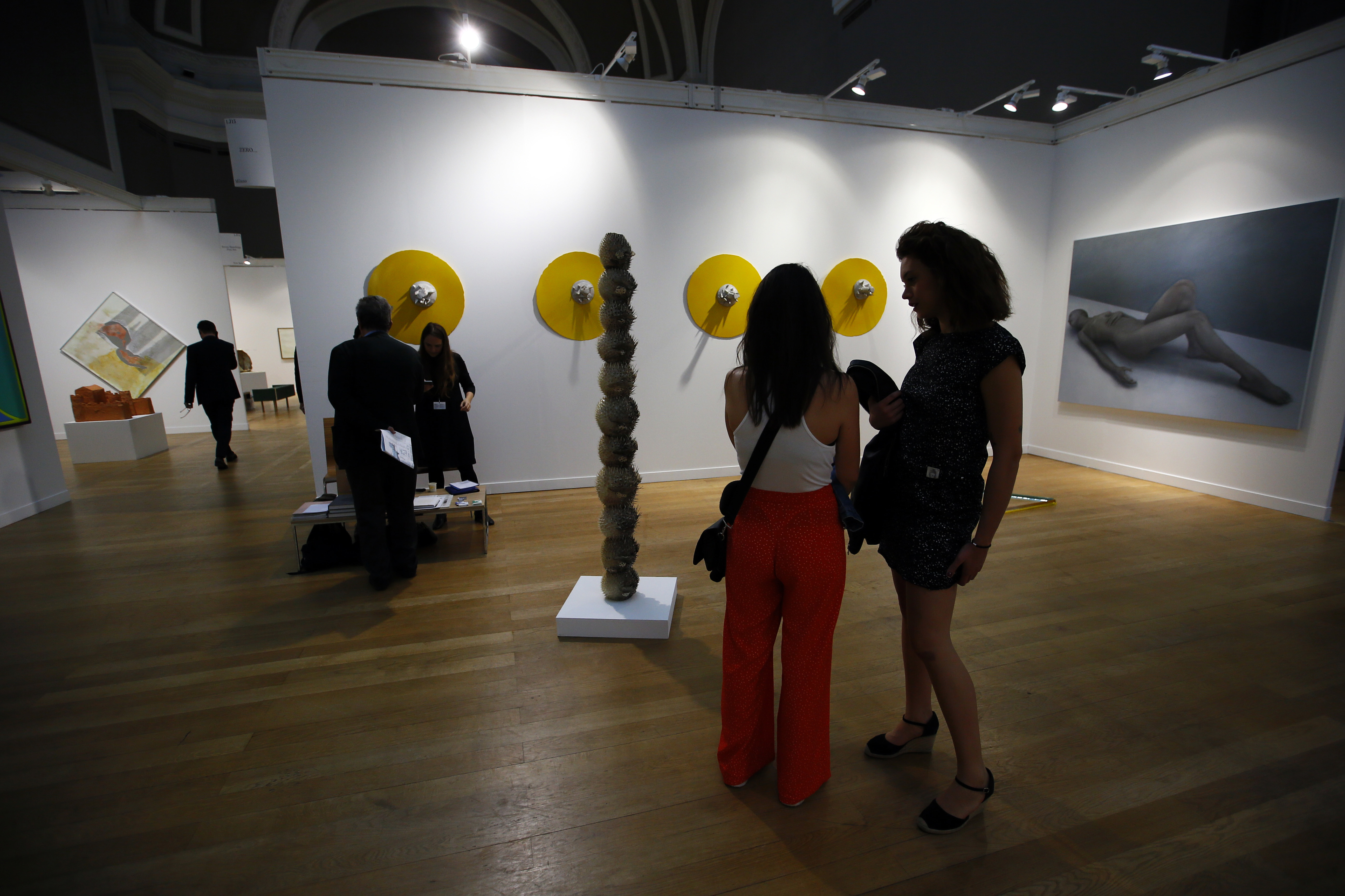 Visitors look on during the opening of the FIAC art fair at the Grand Palais in Paris, France, Thursday Oct. 19, 2017. (AP Photo/Francois Mori)