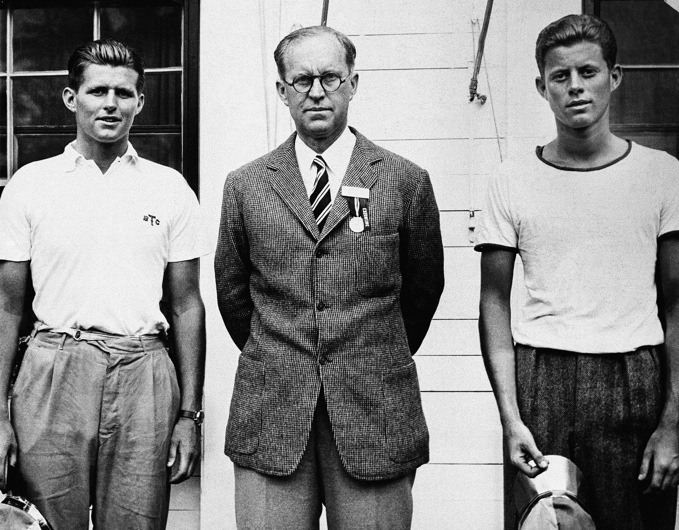Joseph P. Kennedy, center, member of the Harvard class of 1912, with his two sons at the class celebration.   Mr. Kennedy, chairman of the Maritime Commission came to Cambridge, Mass. to attend Harvard commencement on June 23, 1937.    He is shown here with Joseph P. Kennedy  Jr., left, and John F. Kennedy at right.     (AP Photo)
