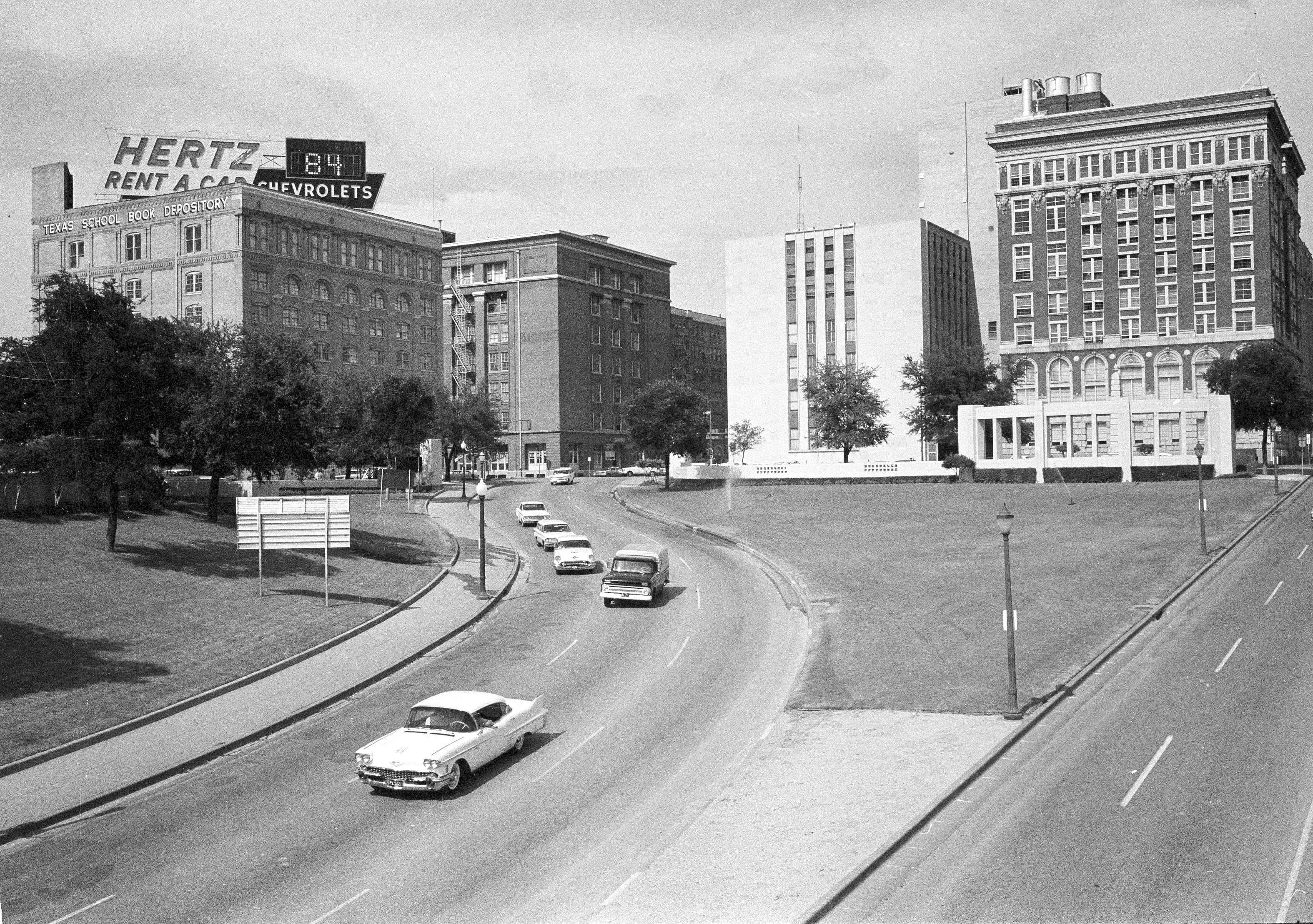 FILE - This May 22, 1964 photo shows Dealey Plaza where U.S. President John F. Kennedy traveled down when shots claimed his life. The building at left is the Texas School Book Depository Building where Lee Harvery Oswald was determined to have fired the shots. (AP Photo/File)