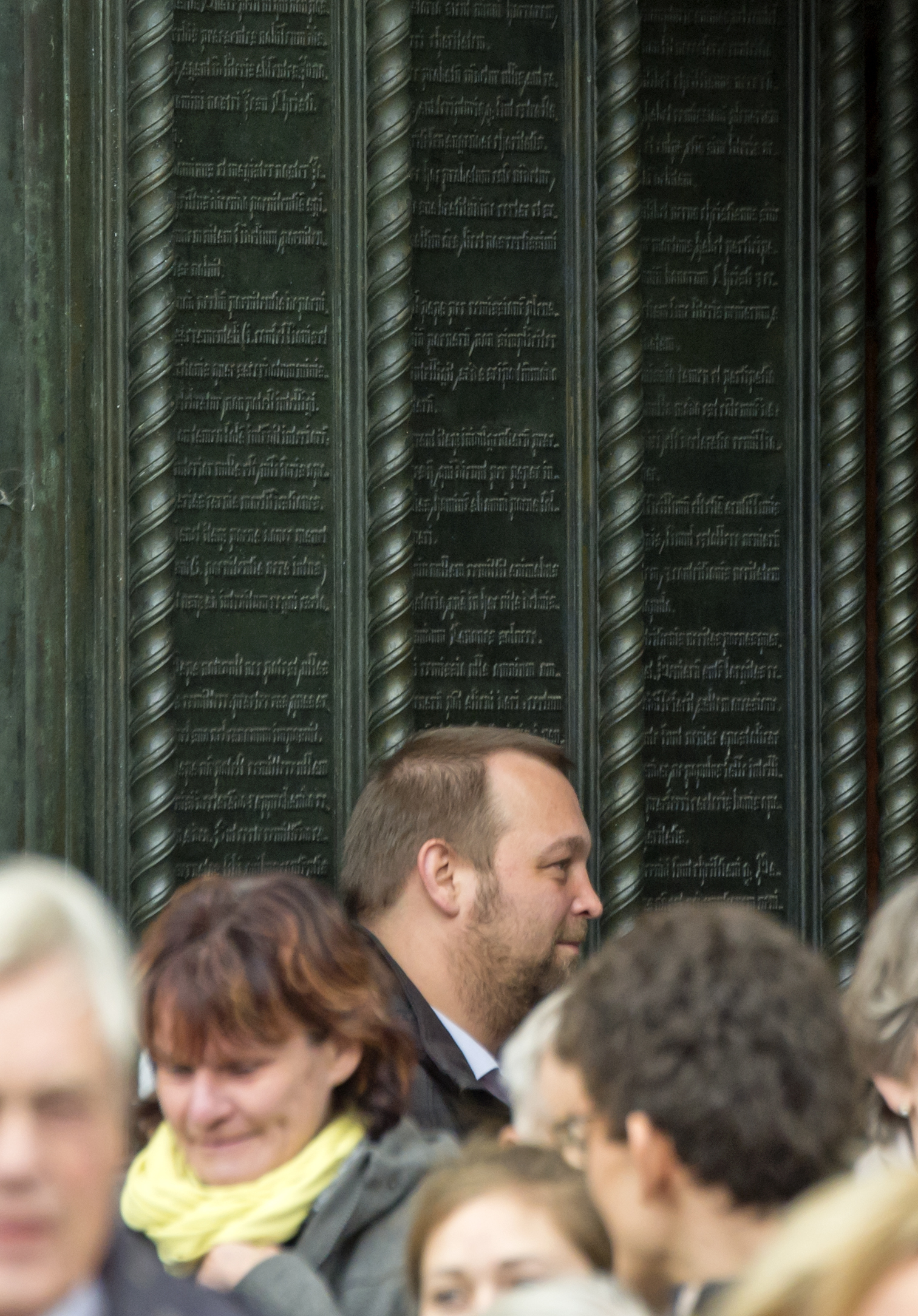 Believers leave after a public service in front of Luther's theses door on the occasion the 500th Anniversary of the Reformation in the Castle Church Wittenberg, Germany, Tuesday, Oct. 31, 2017.  German leaders will mark the 500th anniversary of the day Martin Luther is said to have nailed his theses challenging the Catholic Church's practice of selling indulgences to a church door, a starting point of the Reformation.  (AP Photo/Jens Meyer)