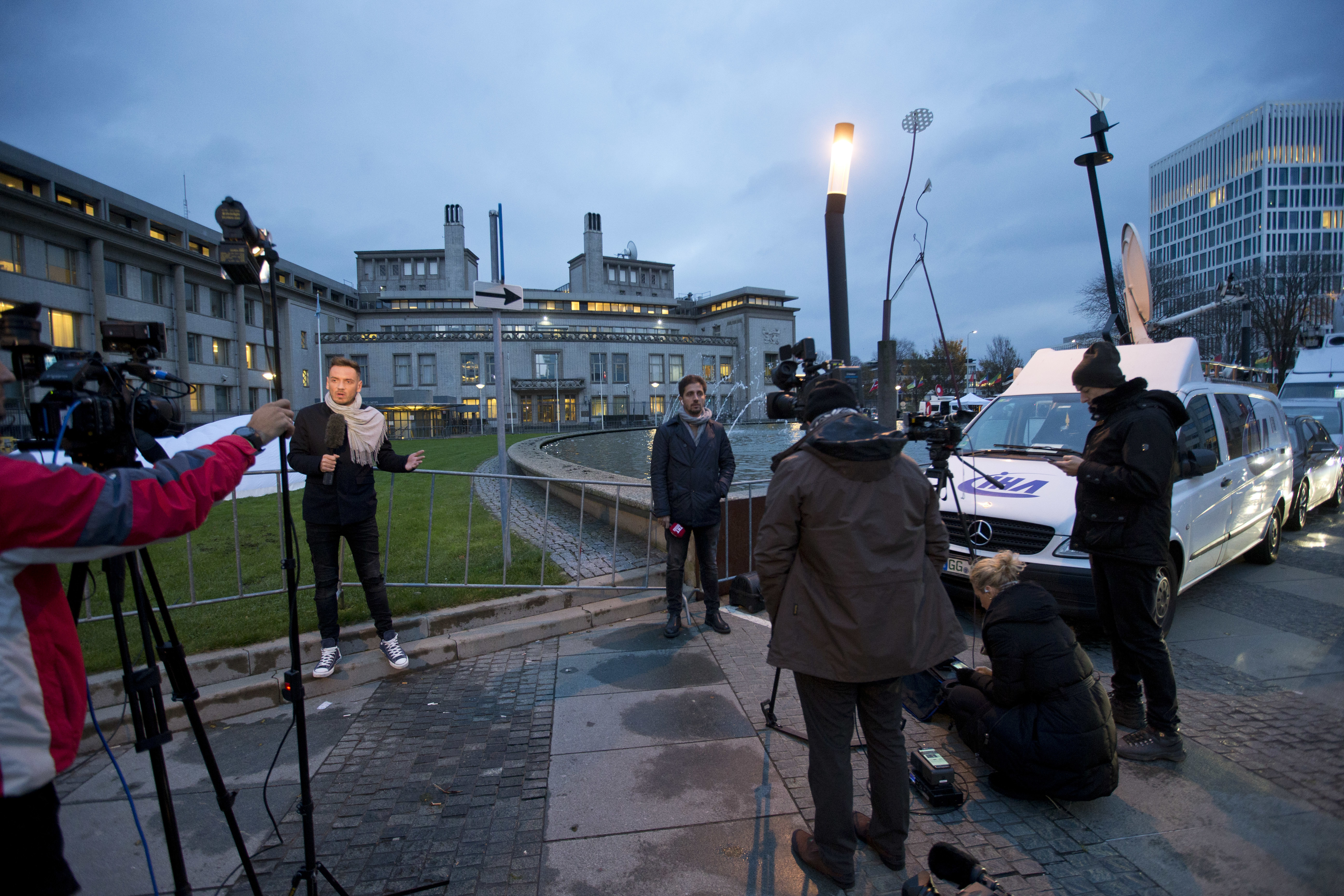 Satellite trucks and cameras are set up outside the Yugoslav War Crimes Tribunal, rear center, where the court is scheduled to hand down the verdict in the genocide case against Bosnian Serb military chief Ratko Mladic, in The Hague, Netherlands, Wednesday, Nov. 22, 2017. Mladic's trial is the last major case for the Netherlands-based tribunal for former Yugoslavia, which was set up in 1993 to prosecute those most responsible for the worst carnage in Europe since World War II. (AP Photo/Peter Dejong)