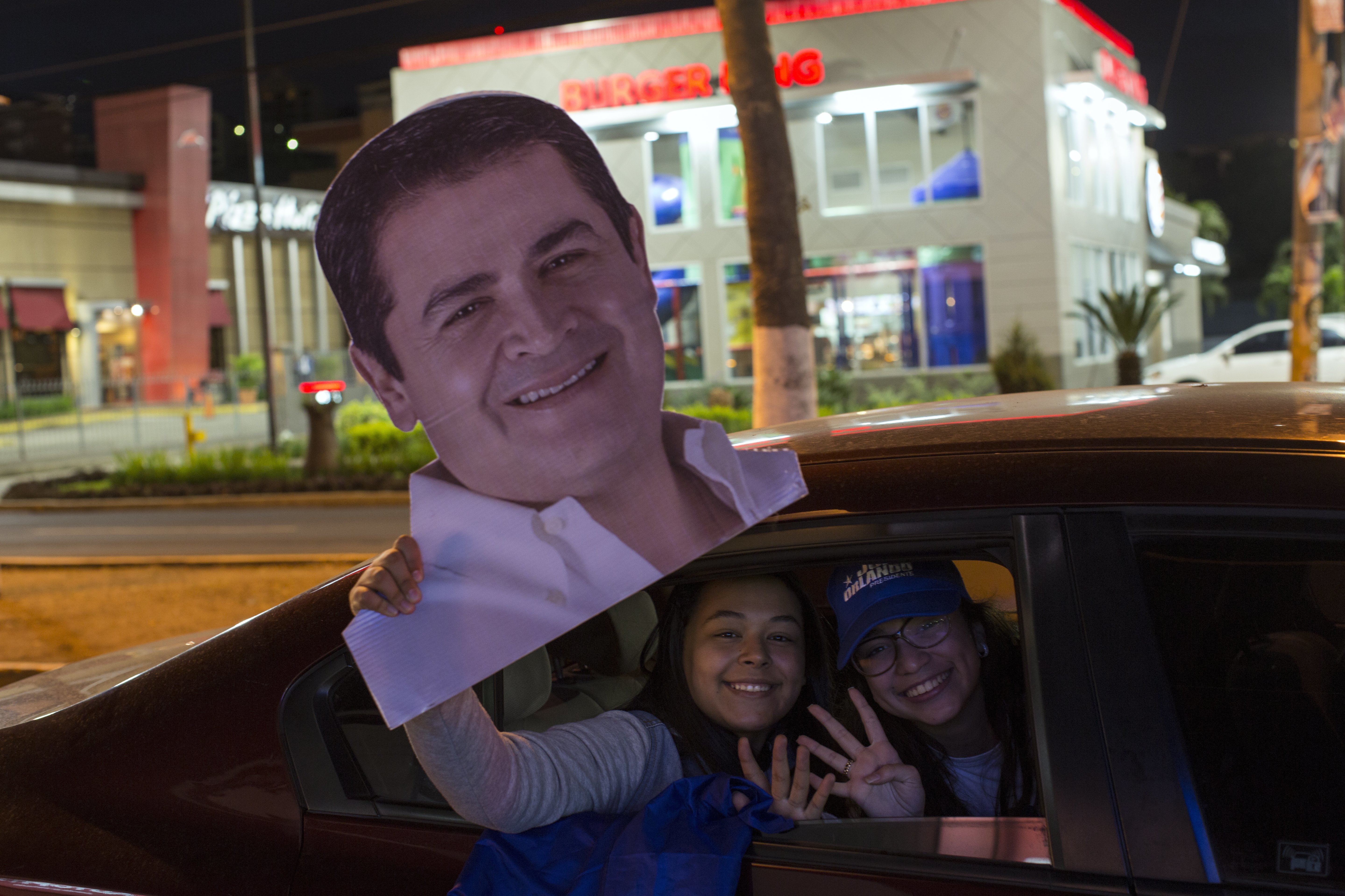 Supporters of Honduran President Juan Orlando Hernandez, who is running for reelection, show support for their candidate as they caravan through Tegucigalpa, Honduras, Wednesday, Nov. 29, 2017. Both Hernandez and his rival Salvador Nasralla have declared themselves the winner of Sunday's presidential election, but the electoral court has not announced the final results. (AP Photo/Rodrigo Abd)