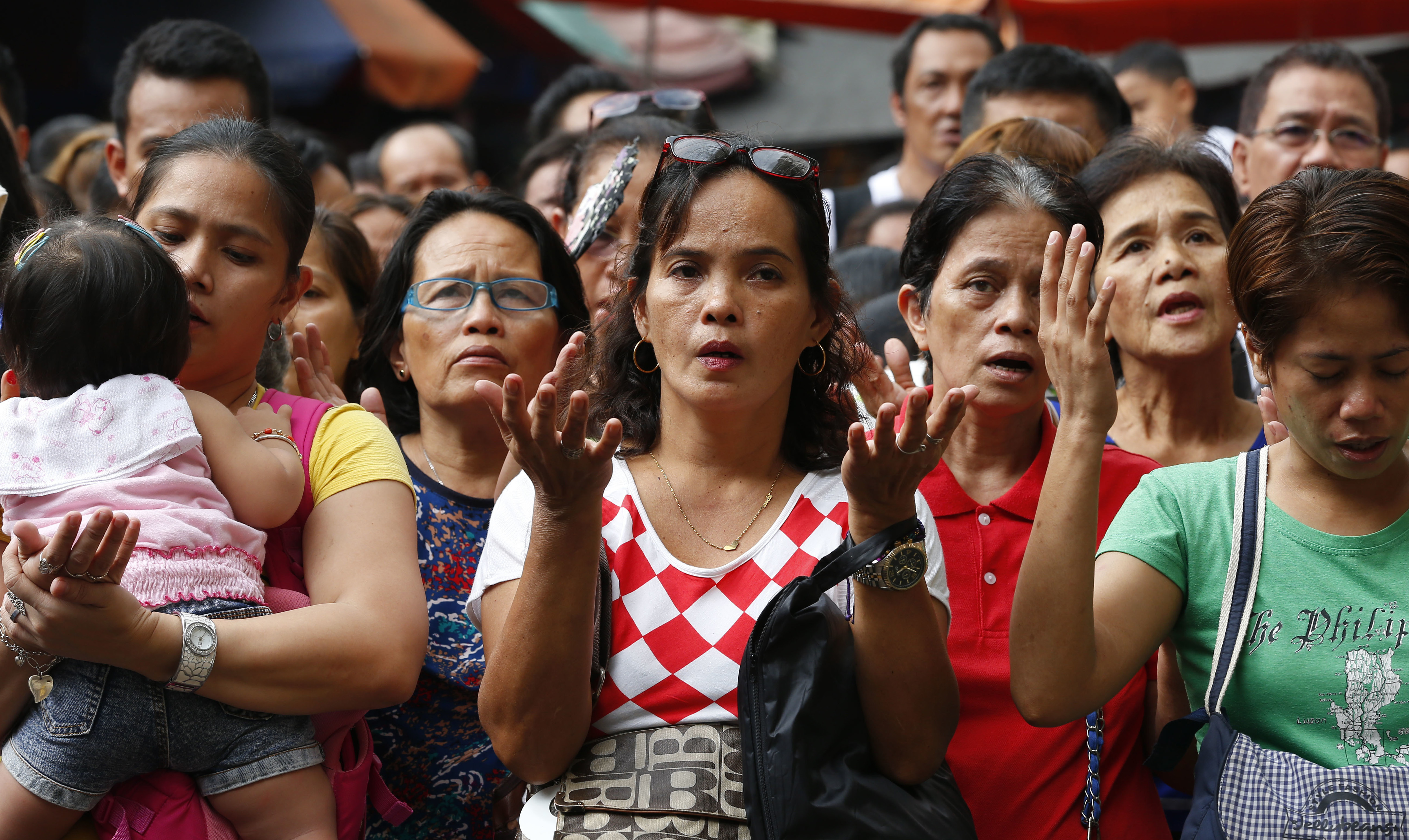 Hundreds of Roman Catholics pray at mass at the Quiapo church ahead of the celebration of the feast day of the Black Nazarene, Friday, Jan. 5, 2018, in Manila, Philippines. Hundreds of thousands of devotees are expected to take part in Tuesday's long, barefoot and raucous procession around the Manila streets. (AP Photo/Bullit Marquez)