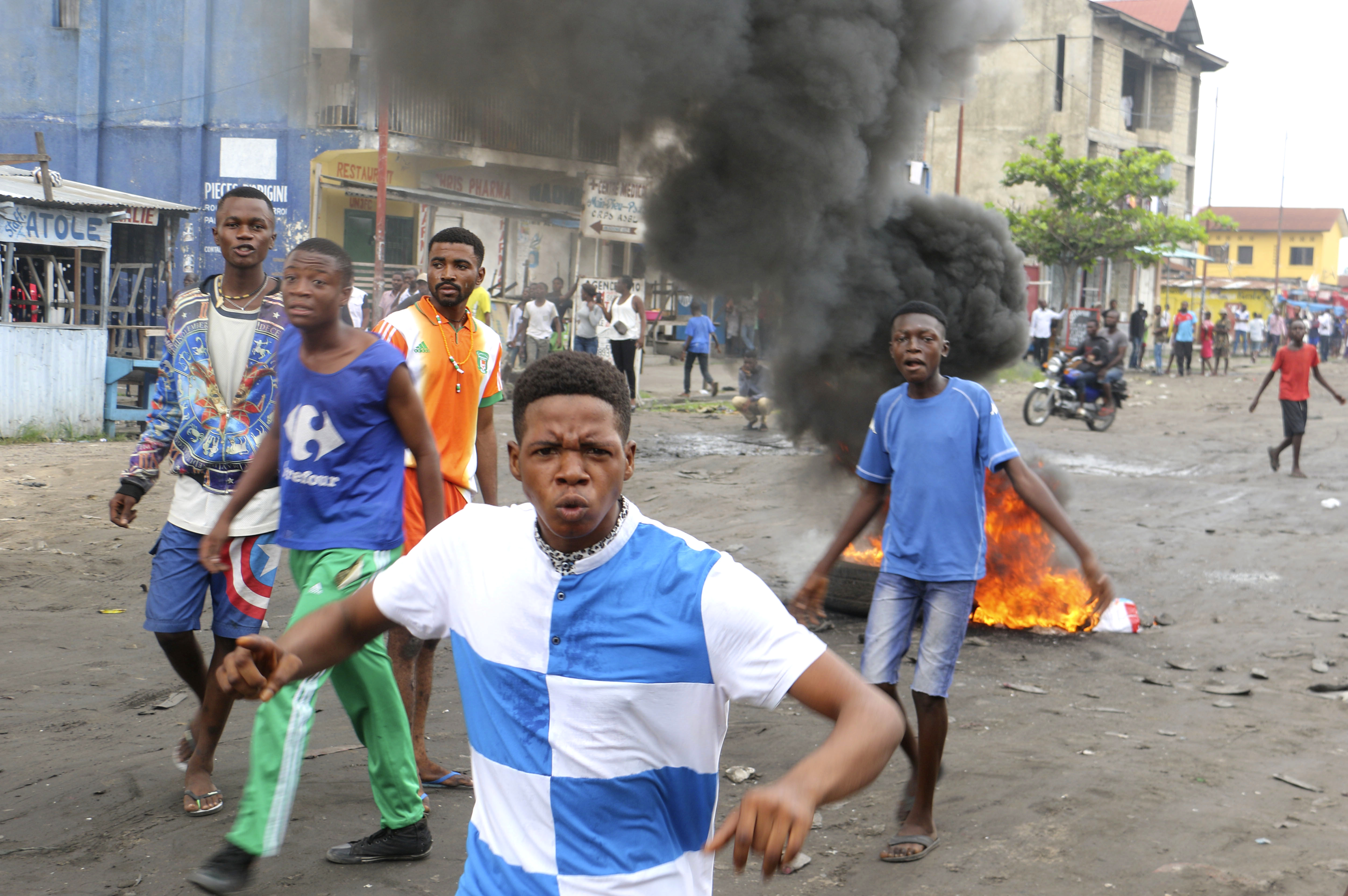 Congolese boys take part in a protest against President Joseph Kabila's refusal to step down from power in Kinshasa, Democratic Republic of Congo, Sunday, Dec. 31, 2017. Congolese security forces shot dead two men outside a church on Sunday while dispersing demonstrators protesting in the country's capital against President Joseph Kabila's refusal to step down from power, according to Human Rights Watch. (AP Photo/John Bompengo)