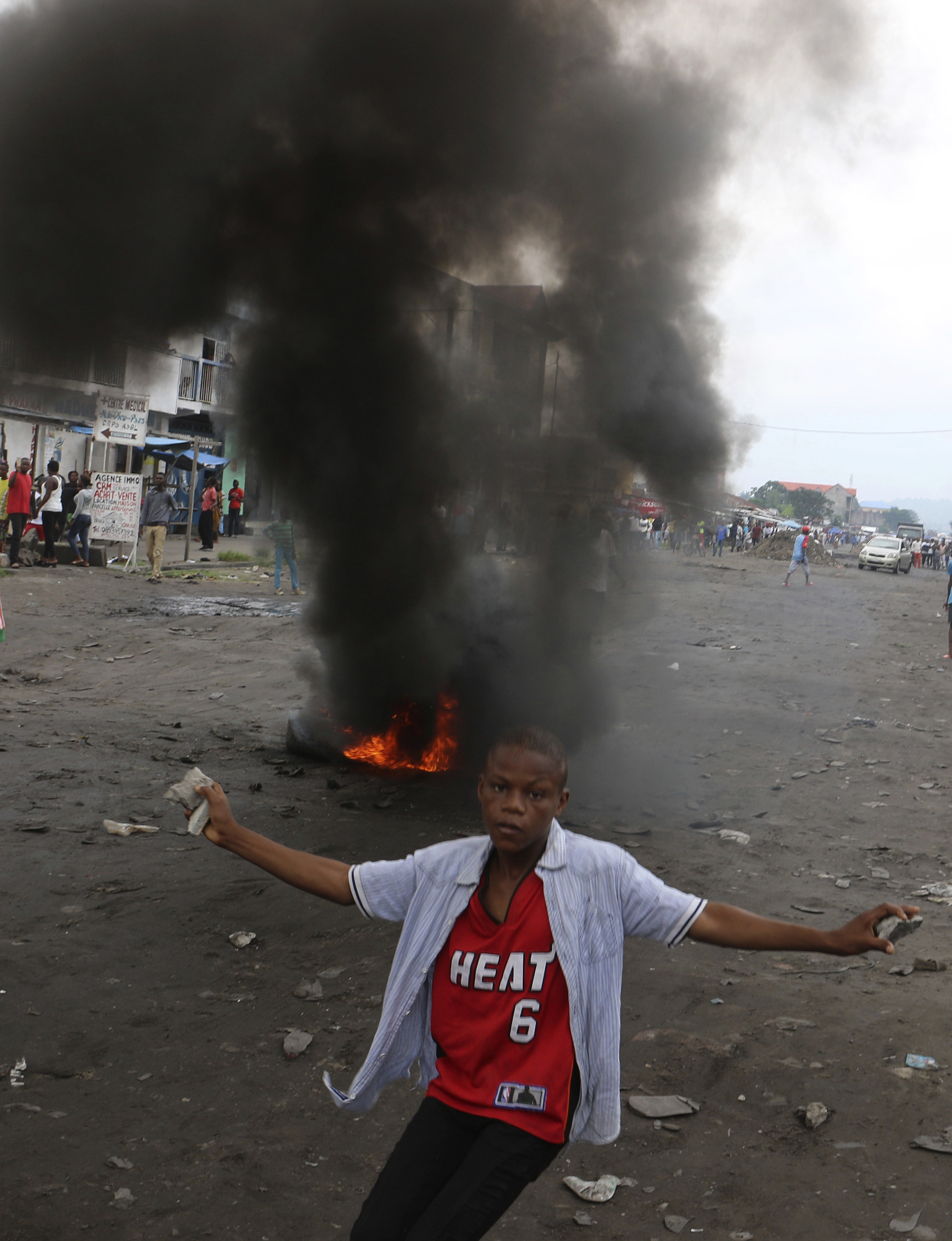 A Congolese boy protests against President Joseph Kabila's refusal to step down from power in Kinshasa, Democratic Republic of Congo, Sunday, Dec. 31, 2017. Congolese security forces shot dead two men outside a church on Sunday while dispersing demonstrators protesting in the country's capital against President Joseph Kabila's refusal to step down from power, according to Human Rights Watch. (AP Photo/John Bompengo)
