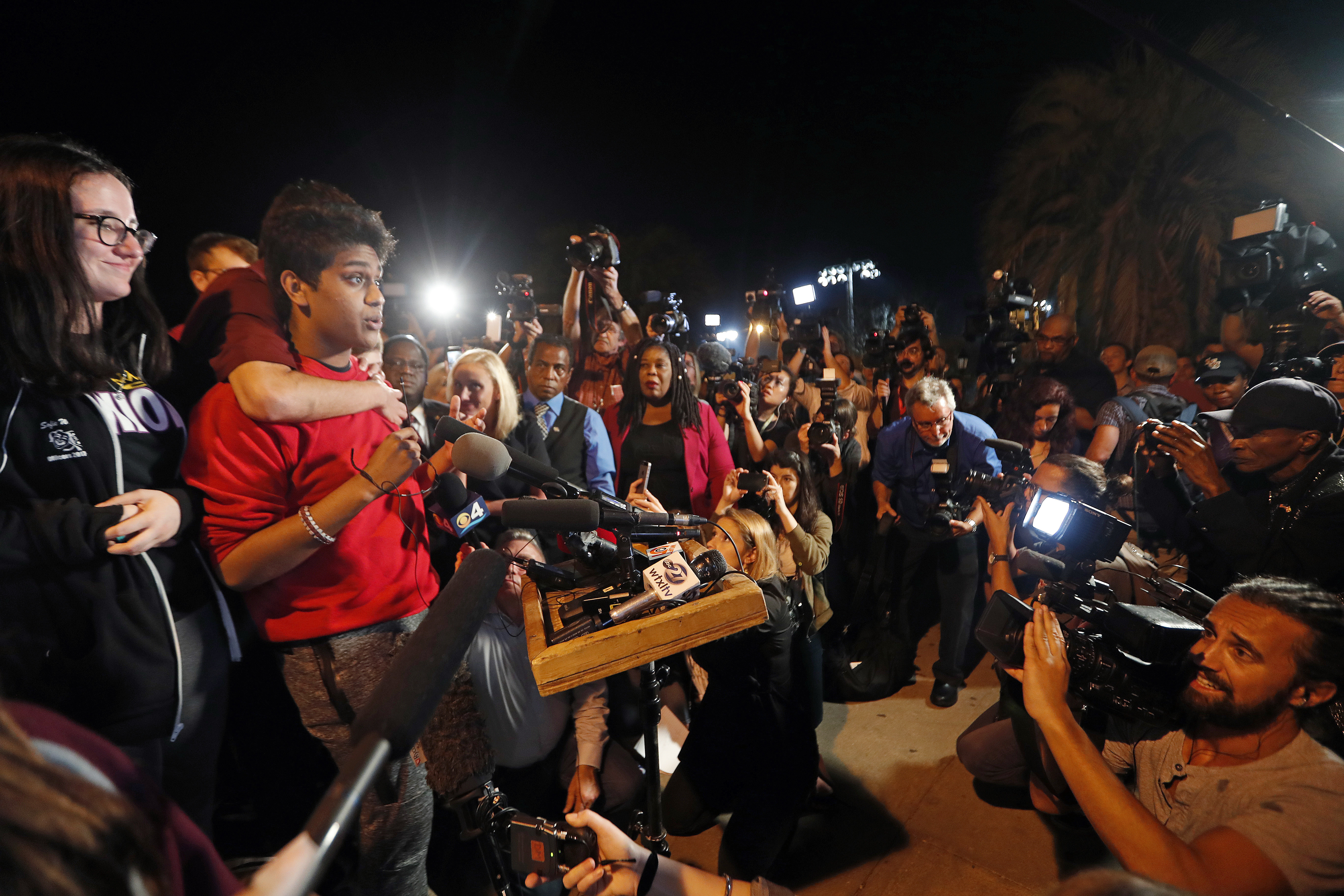 Tanzil Philip, 16, a student survivor from Marjory Stoneman Douglas High School, where 17 students and faculty were killed in a mass shooting on Wednesday, speaks to a crowd of supporters and media as they arrive at Leon High School, in Tallahassee, Fla., Tuesday, Feb. 20, 2018. The students arrived in the state's capital to talk to legislators and rally for gun control reform. (AP Photo/Gerald Herbert)