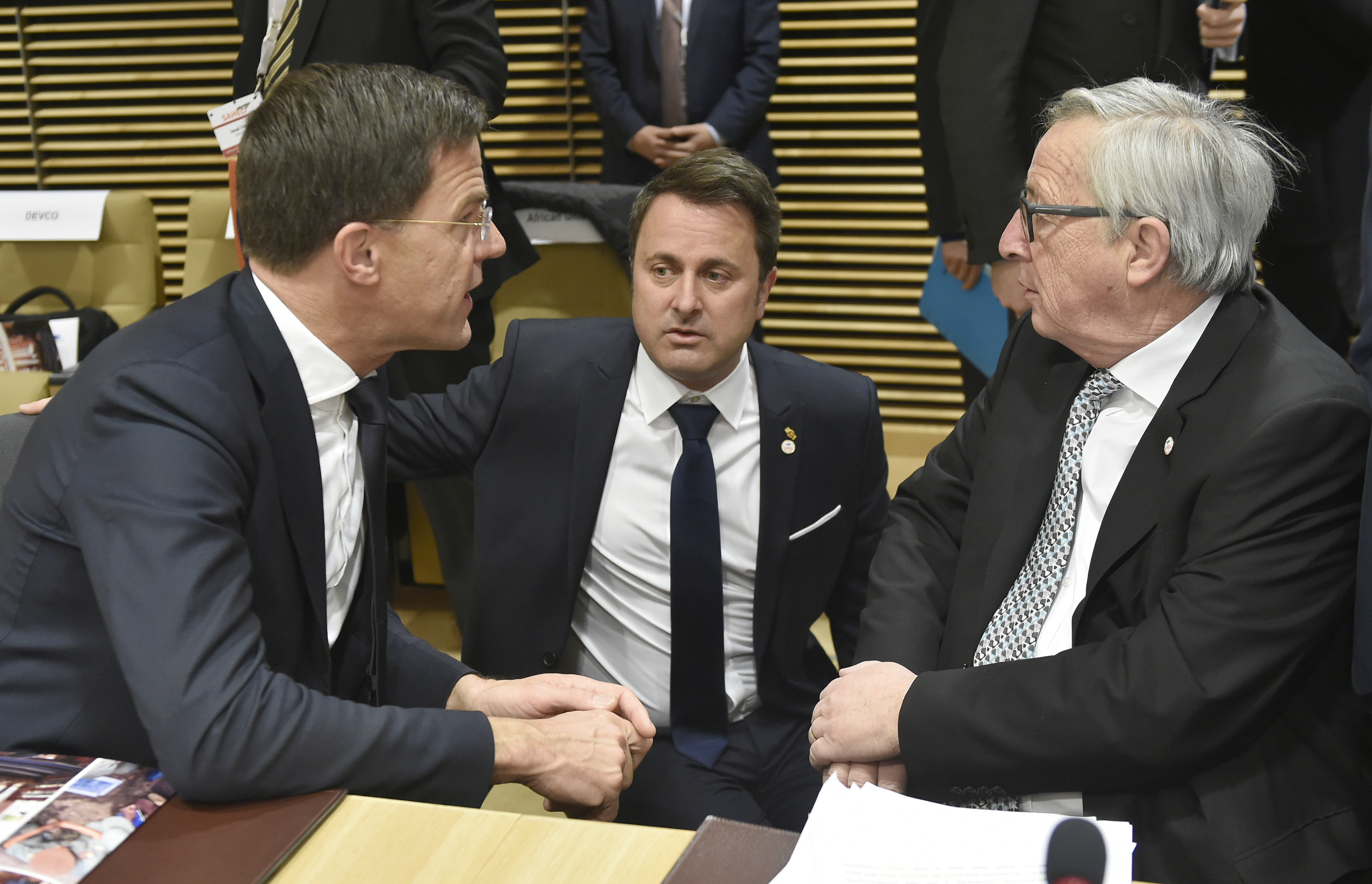 Dutch Prime Minister Mark Rutte, left, speaks with Luxembourg's Prime Minister Xavier Bettel, center, and European Commission President Jean-Claude Juncker during a round table meeting of the EU-Sahel at EU headquarters in Brussels on Friday, Feb. 23, 2018. European Union leaders meet Friday with counterparts from Africa's Sahel in a show of support for the impoverished region fallen prey to extremists and a key transit point for migrants heading to Europe. (John Thys, Pool Photo via AP)